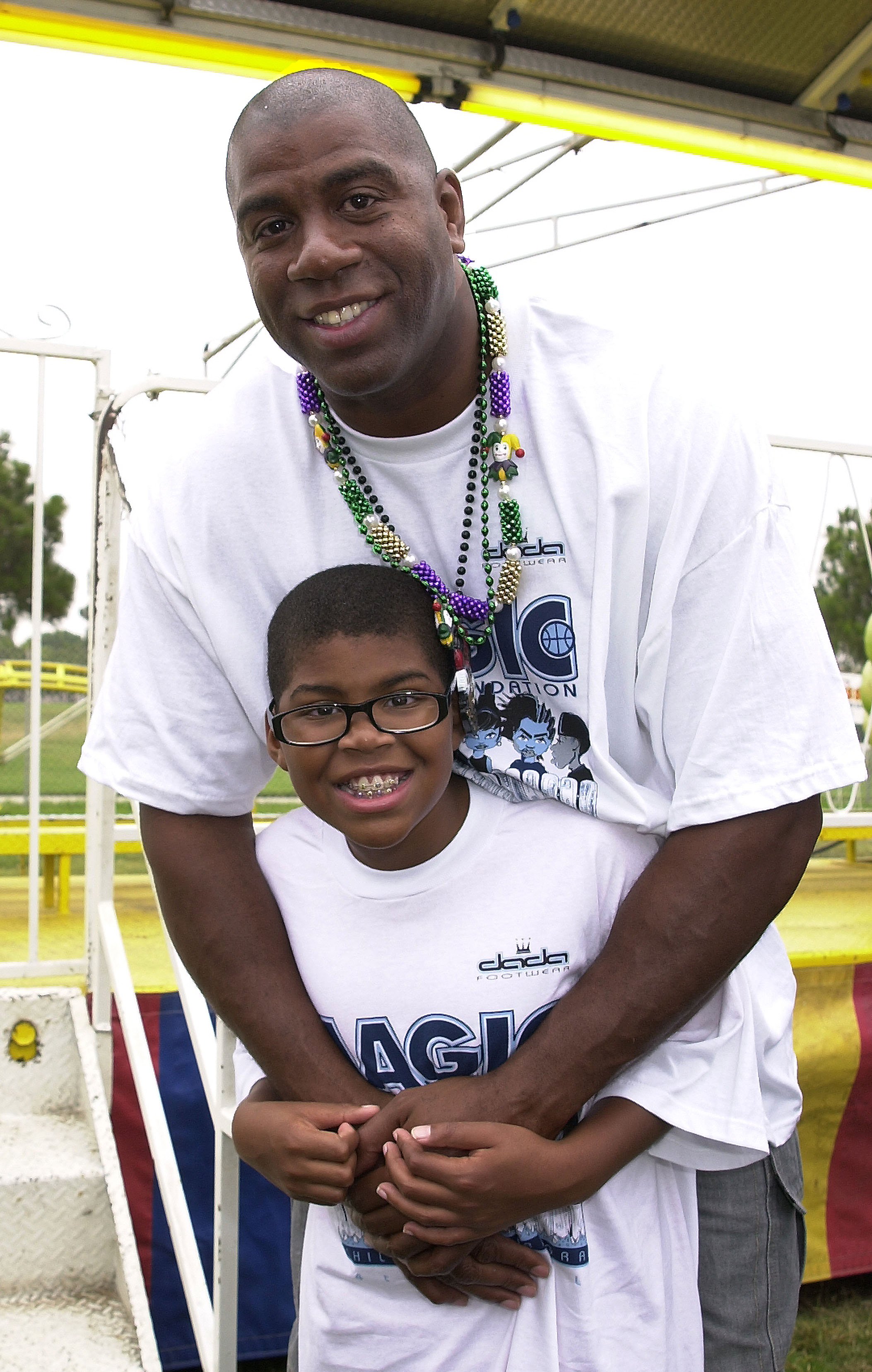 Magic Johnson and his son EJ Johnson during Magic Johnson Foundation's 4th Annual Children's Mardi Gras at Earvin "Magic" Johnson Recreation Center in Los Angeles, California. / Source: Getty Images