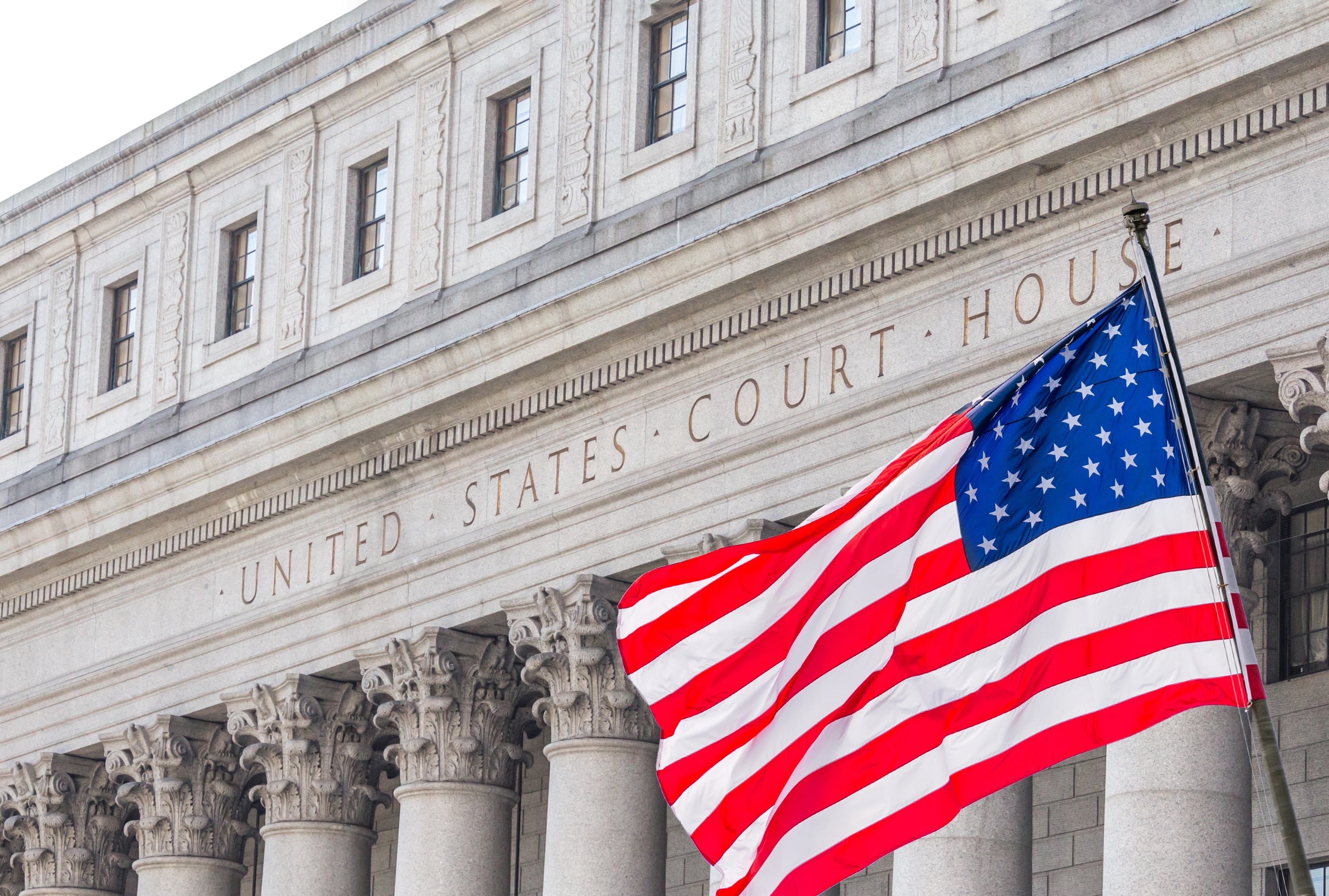 A courthouse with an American flag flying outside | Source: Shutterstock