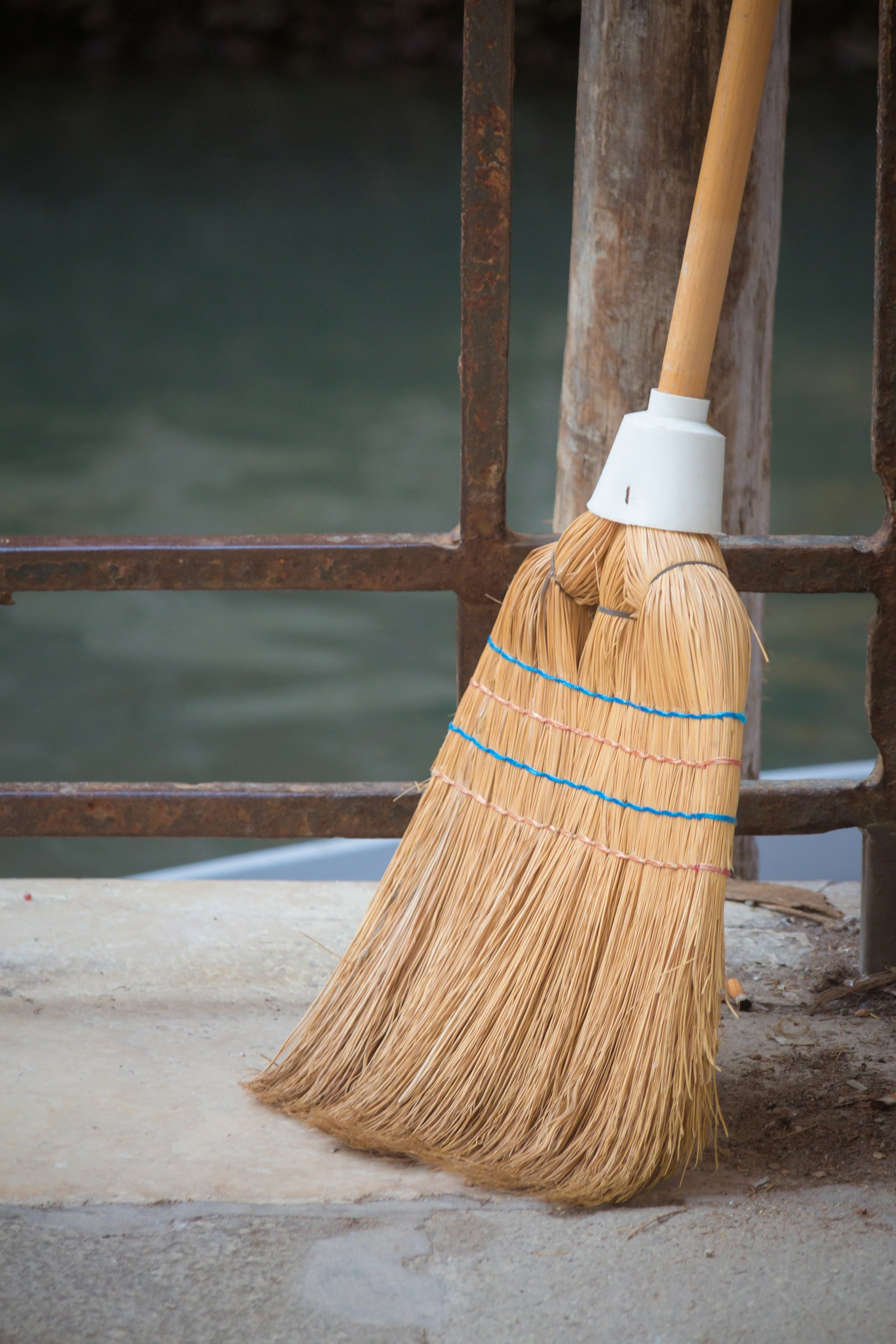 A broom near a fence | Source: Unsplash