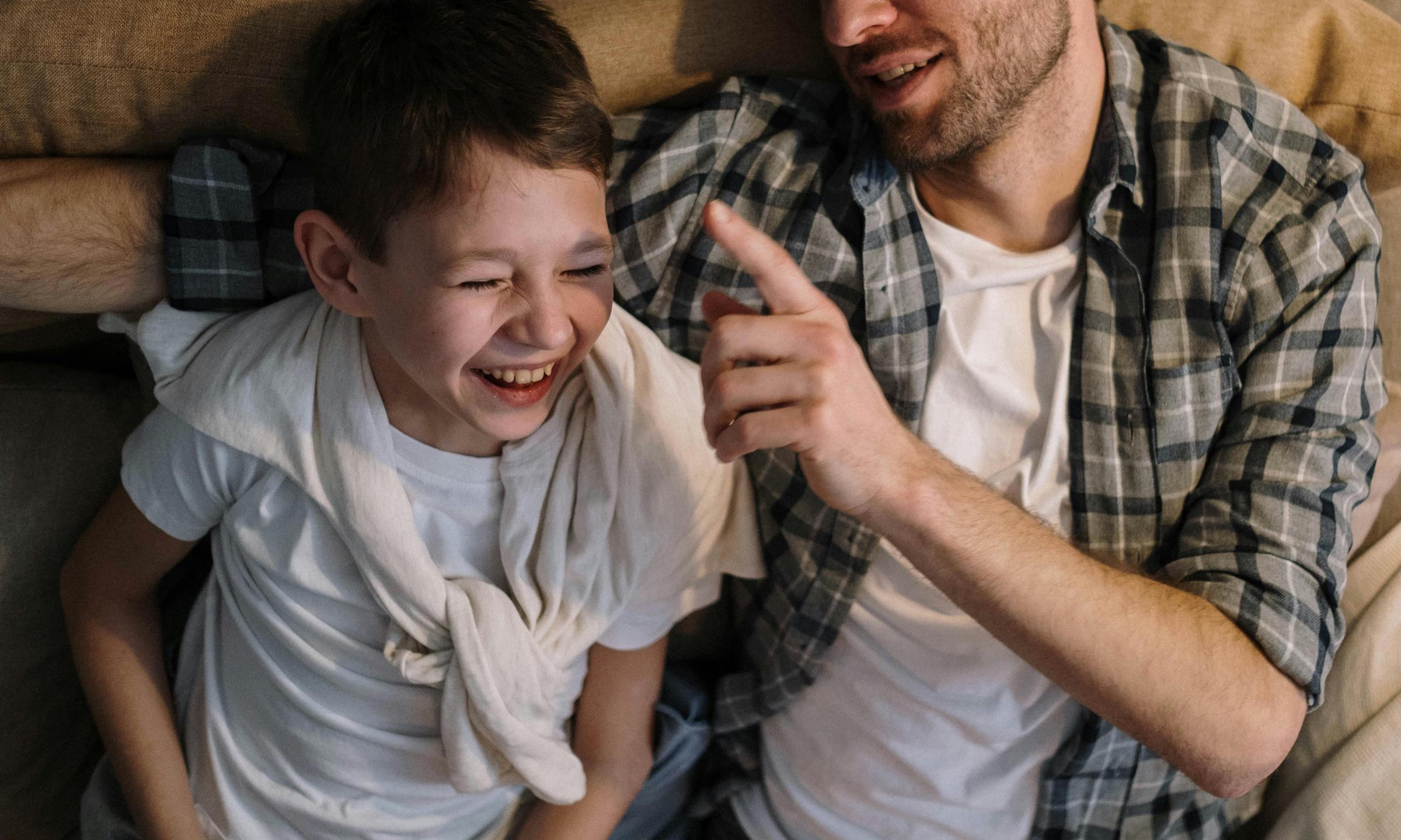 A man and boy laughing together | Source: Pexels
