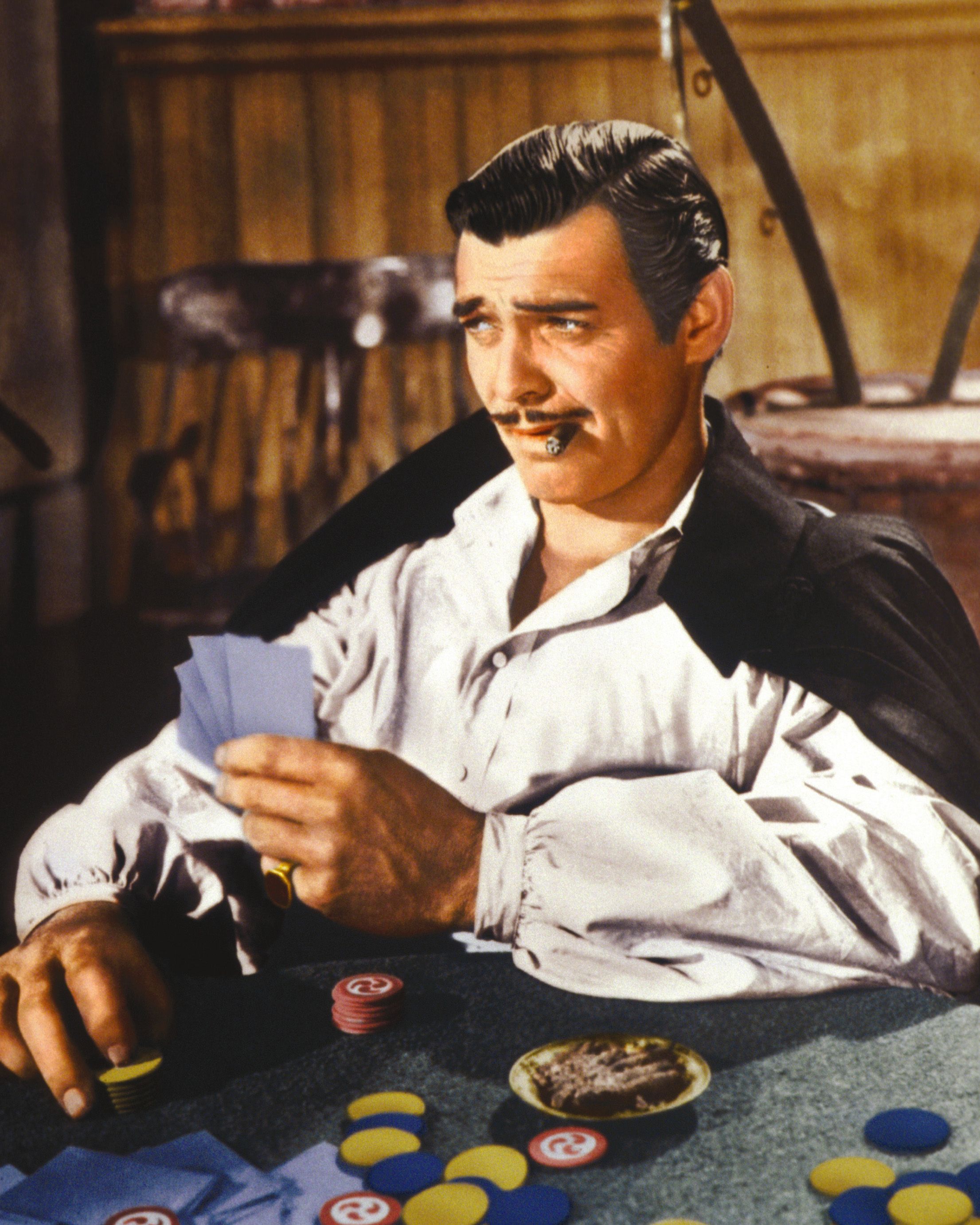 Clark Gable playing cards and smoking a cigar in a publicity still issued for the film "Gone With The Wind," 1939. | Source: Getty Images
