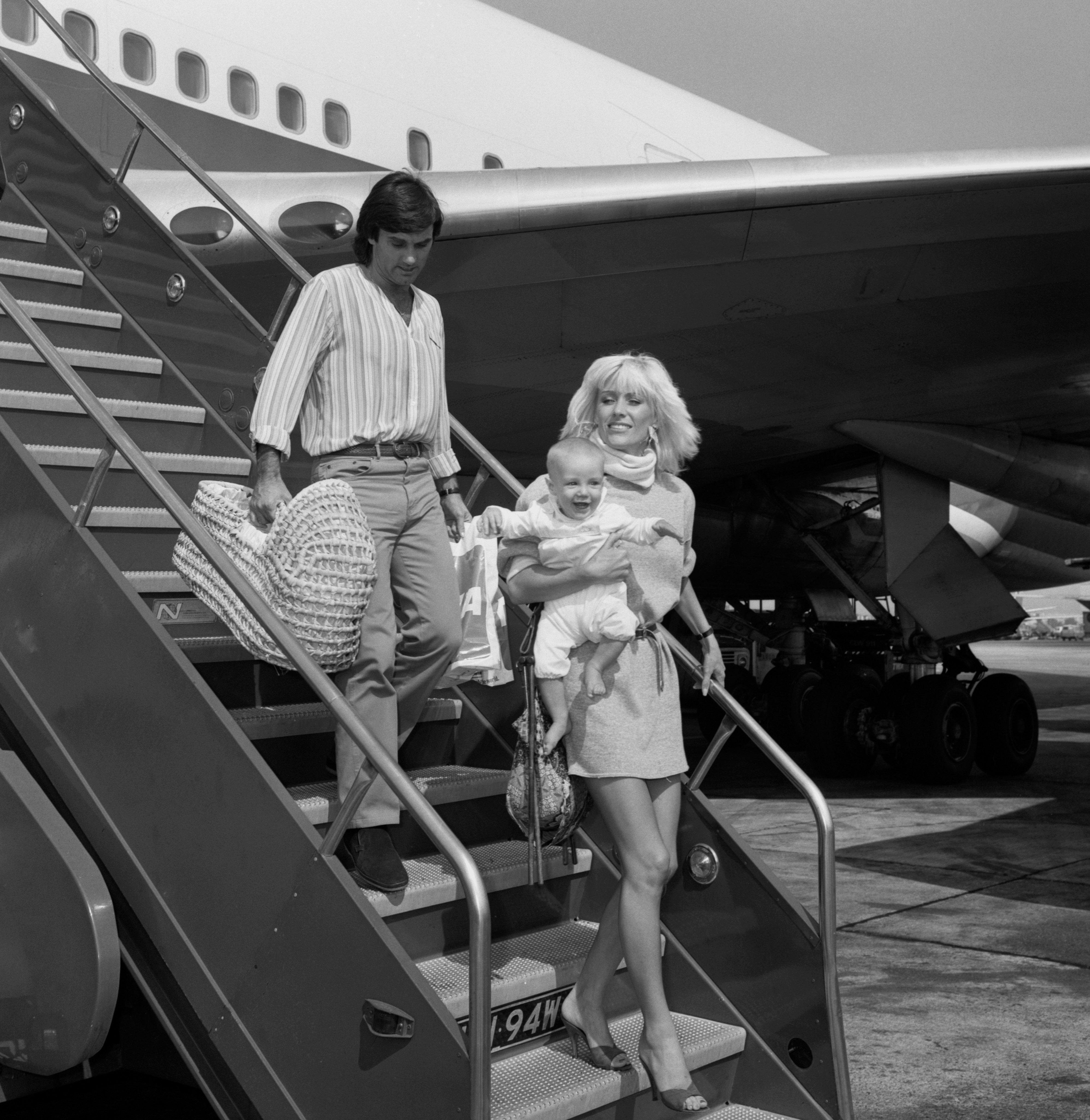Former football legend George Best is pictured at Heathrow Airport with his wife Angie and their young son Calum, the trio photographed during a moment of everyday family life as they travel together.