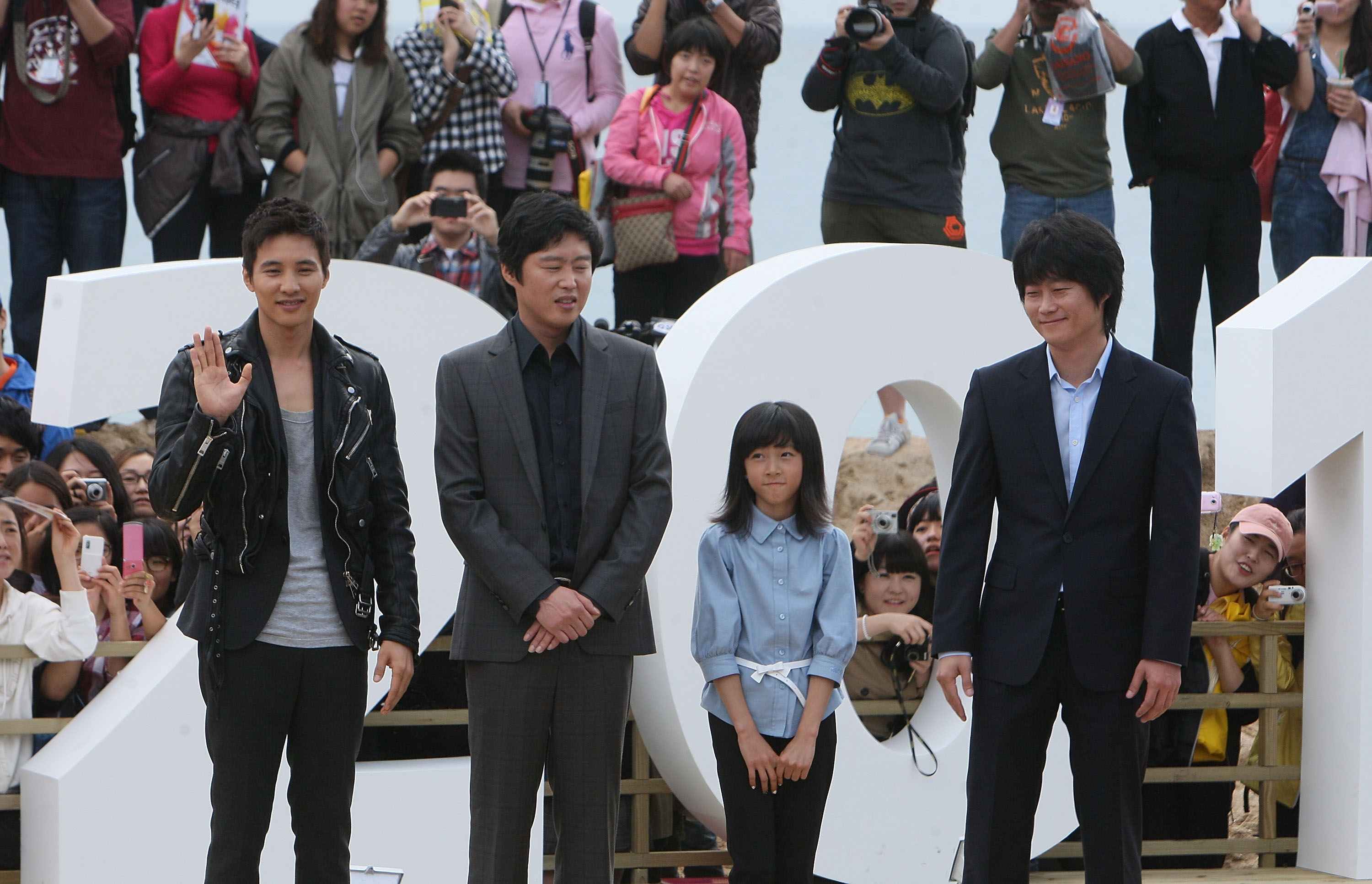 Director Lee Jung-Bum, actors Won Bin and Kim Sae-Ron, and a guest at "The Man From Nowhere" event during the 15th Pusan International Film Festival on October 8, 2010 | Source: Getty Images