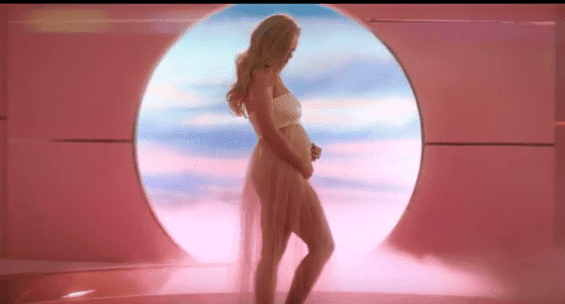 Katy Perry cradles her baby bump at the end of her music video to "Never Worn White." | Source: YouTube/Katy Perry.