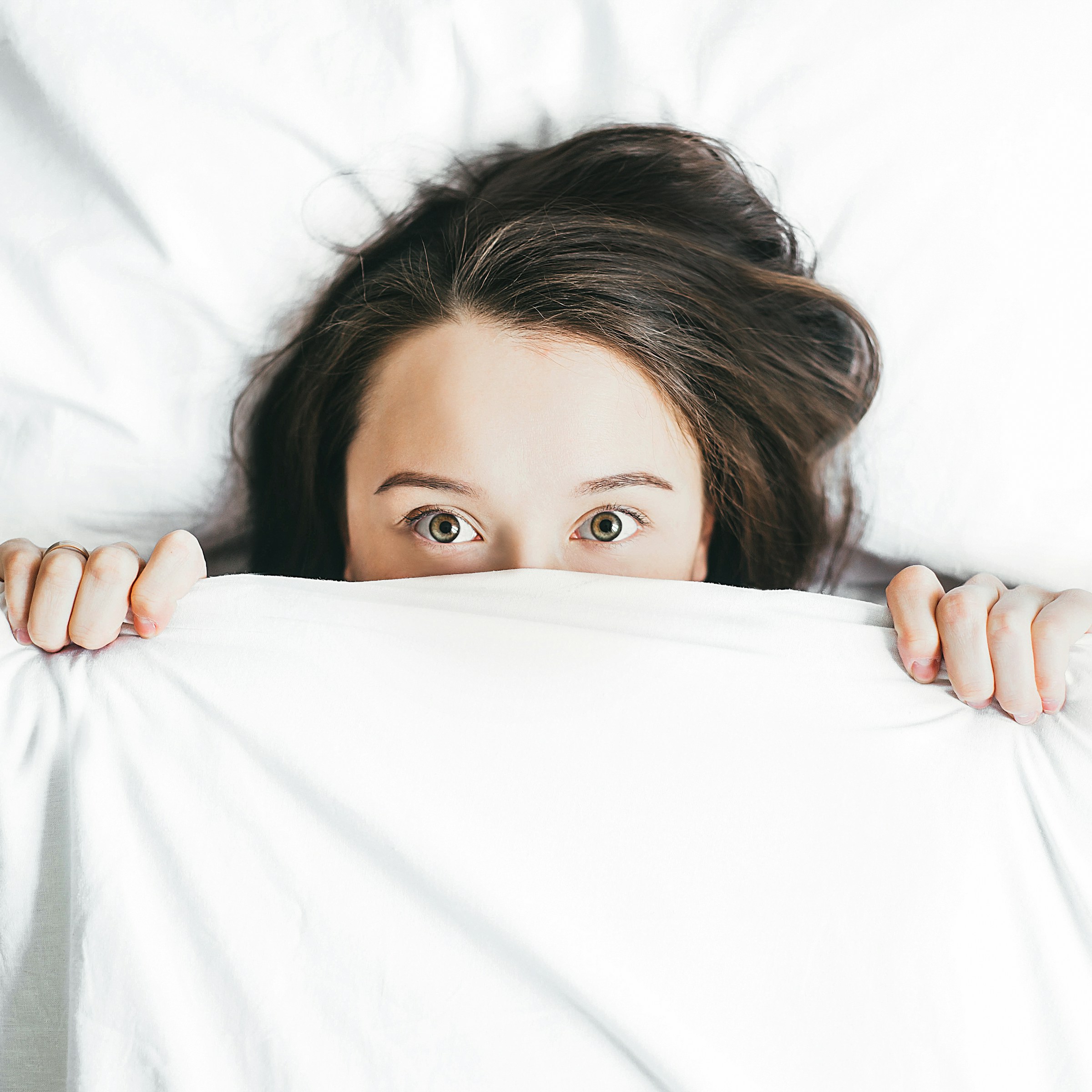 A woman in bed with her eyes wide open | Source: Unsplash