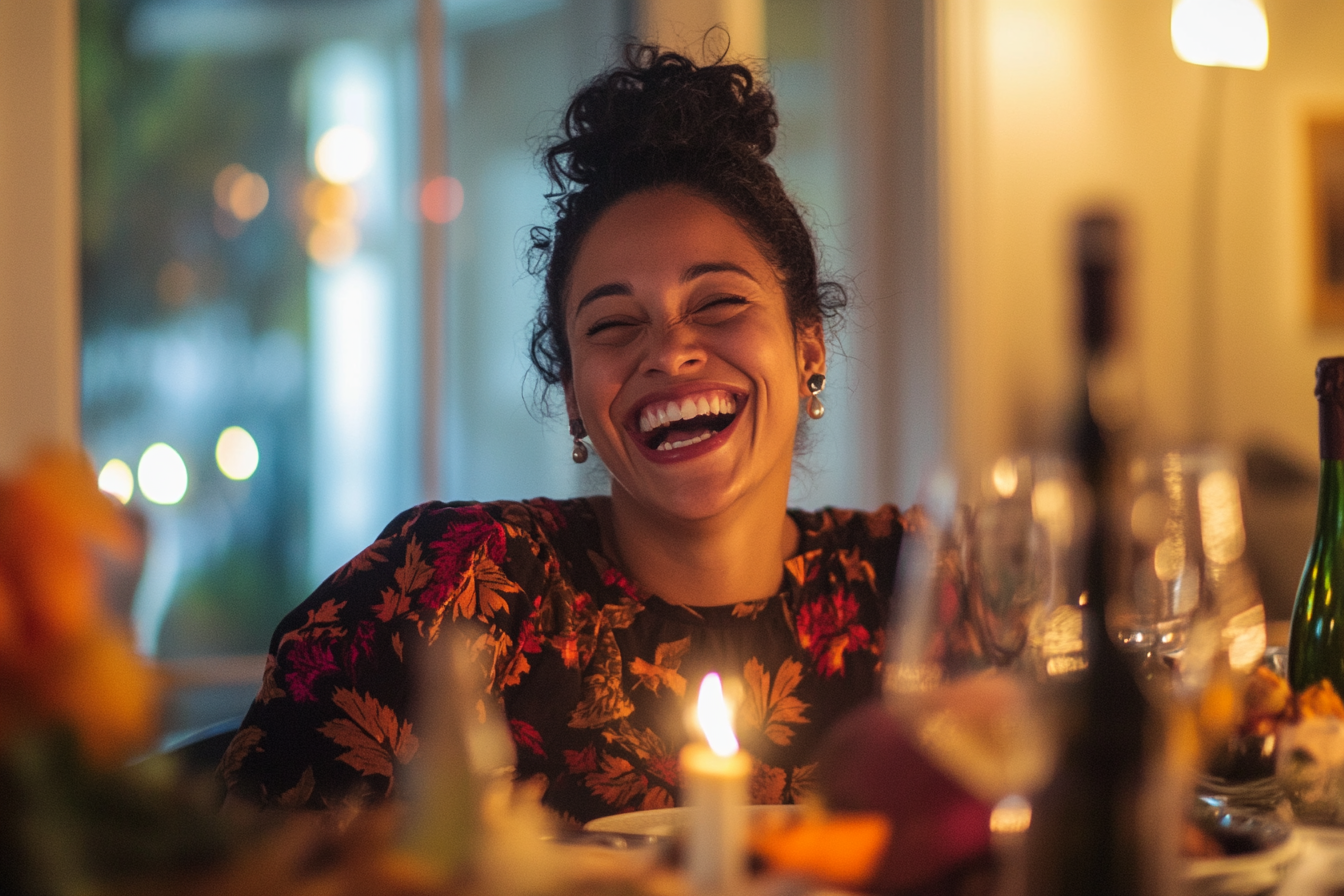 A woman laughing at the dinner table | Source: Midjourney