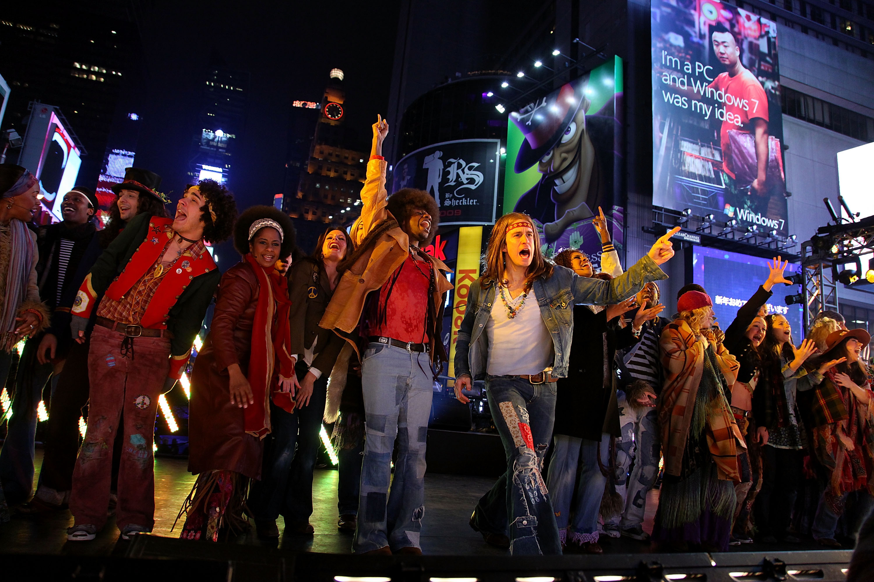 Gavin Creel (center) and the cast of "HAIR" perform New Year's Eve in Times Square in New York City, on December 31, 2009 | Source: Getty Images