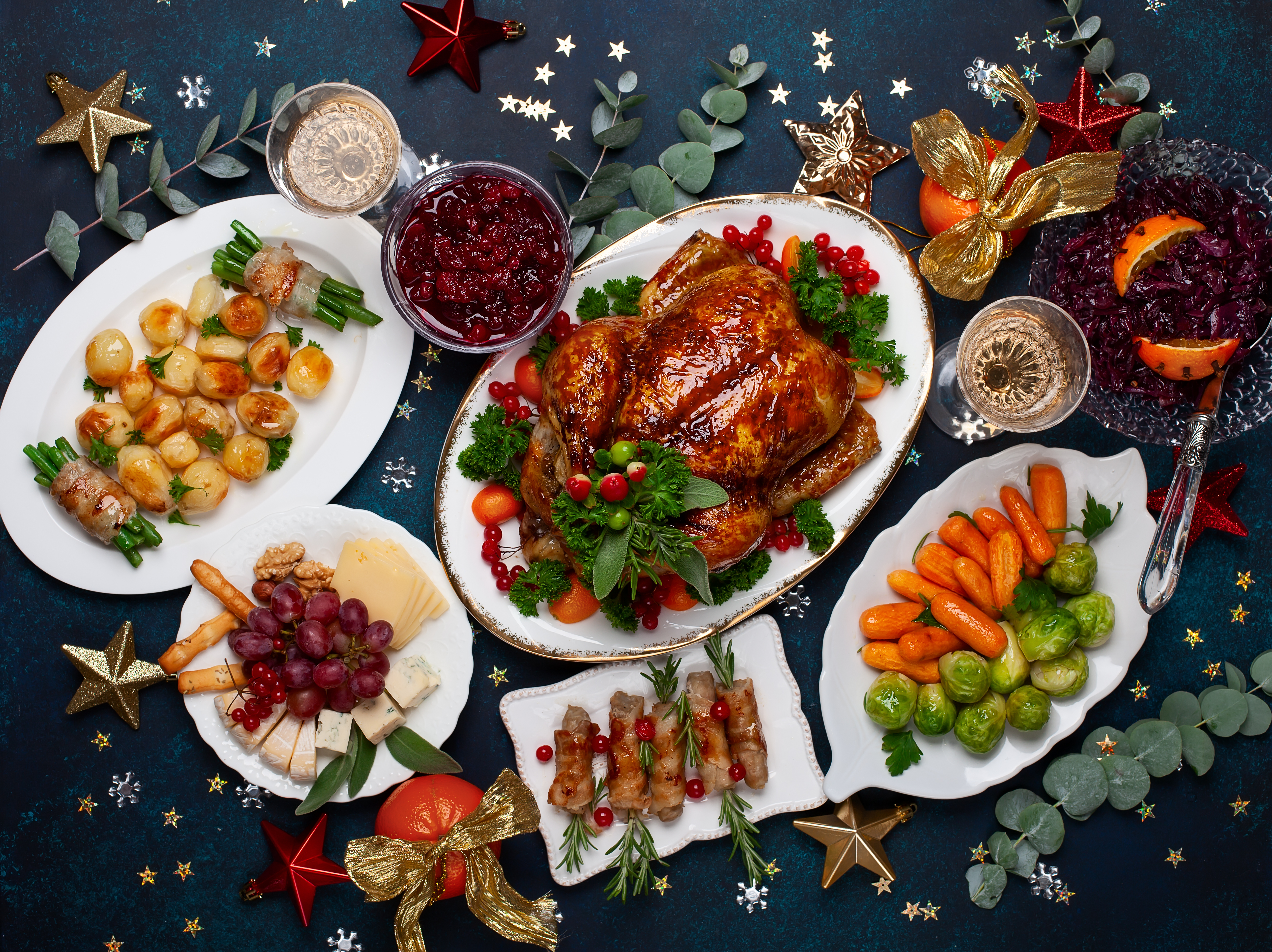 A Christmas dinner laid out on a decorated table | Source: Shutterstock