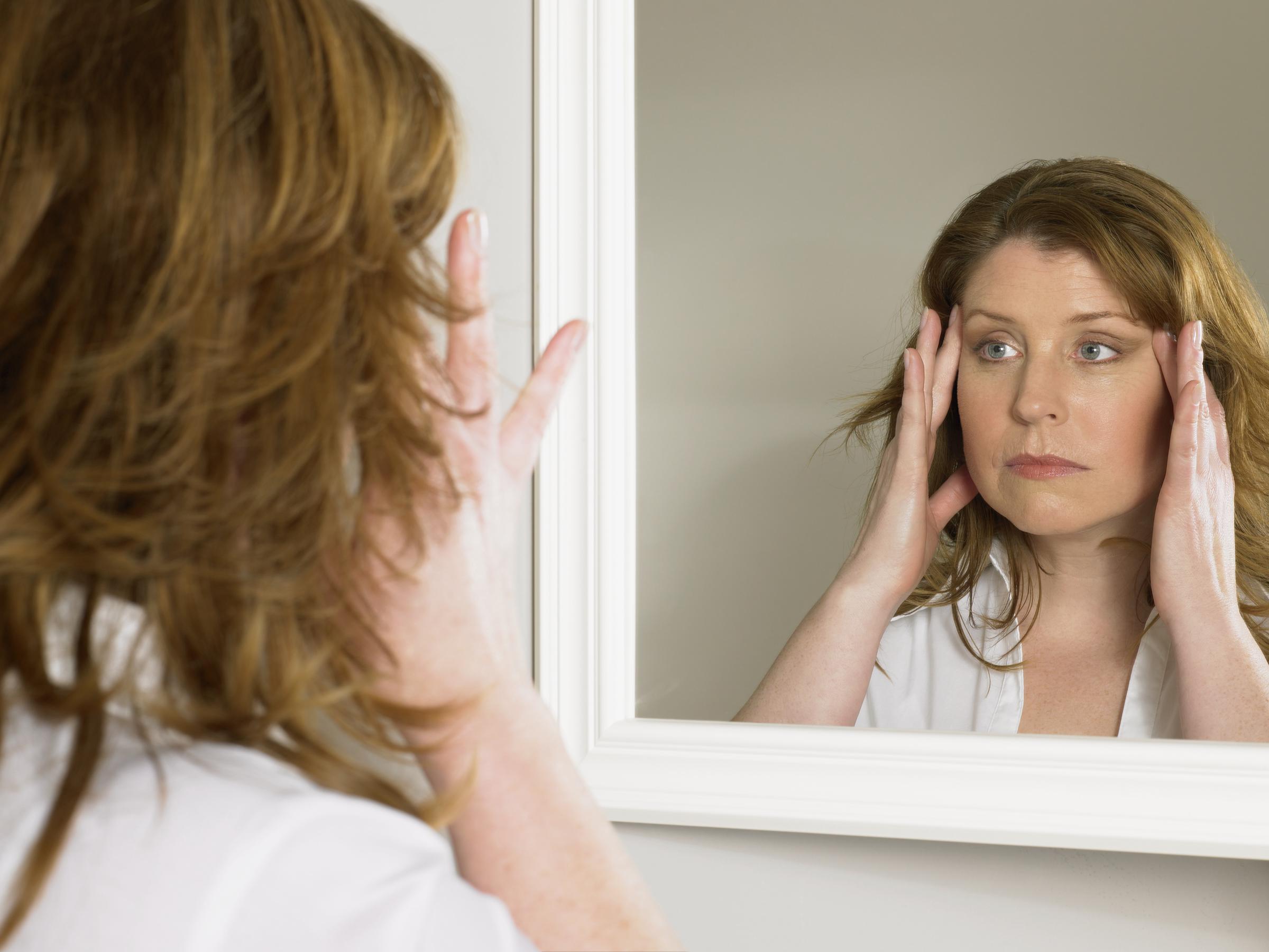 A woman looking at herself in the mirror | Source: Getty Images