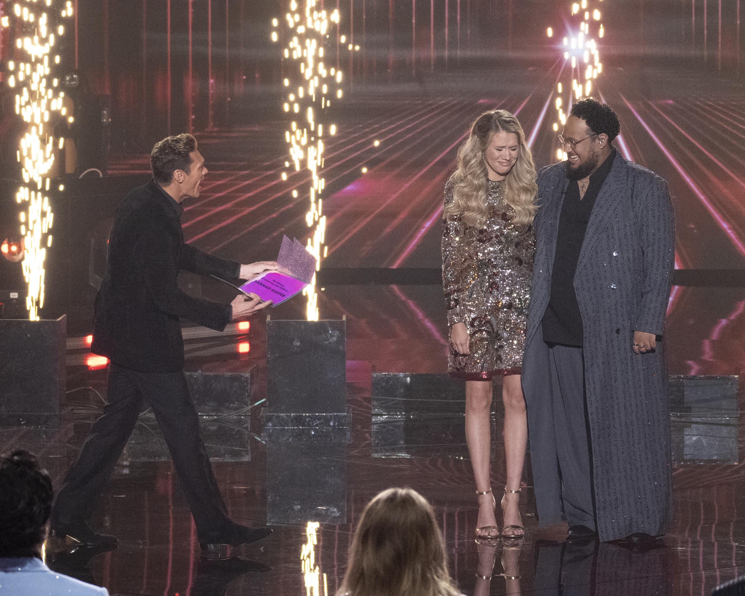 Ryan Seacrest announces the winner as finalists Hannah Harper and Jordan McCullough stand together onstage during the "American Idol" Season 24 grand finale | Source: Getty Images
