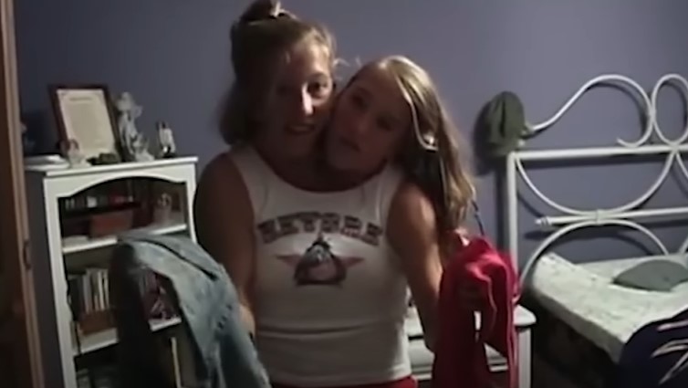 Brittany and Abby Hensel shown trying to decide what to wear during their high school days | Source: YouTube/Screen Static