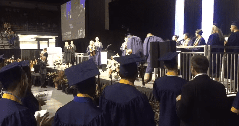 Kolton Smith, the paralyzed high school student walking to receive diploma on stage.| Photo: Facebook/ Hillsborough County Public Schools. 