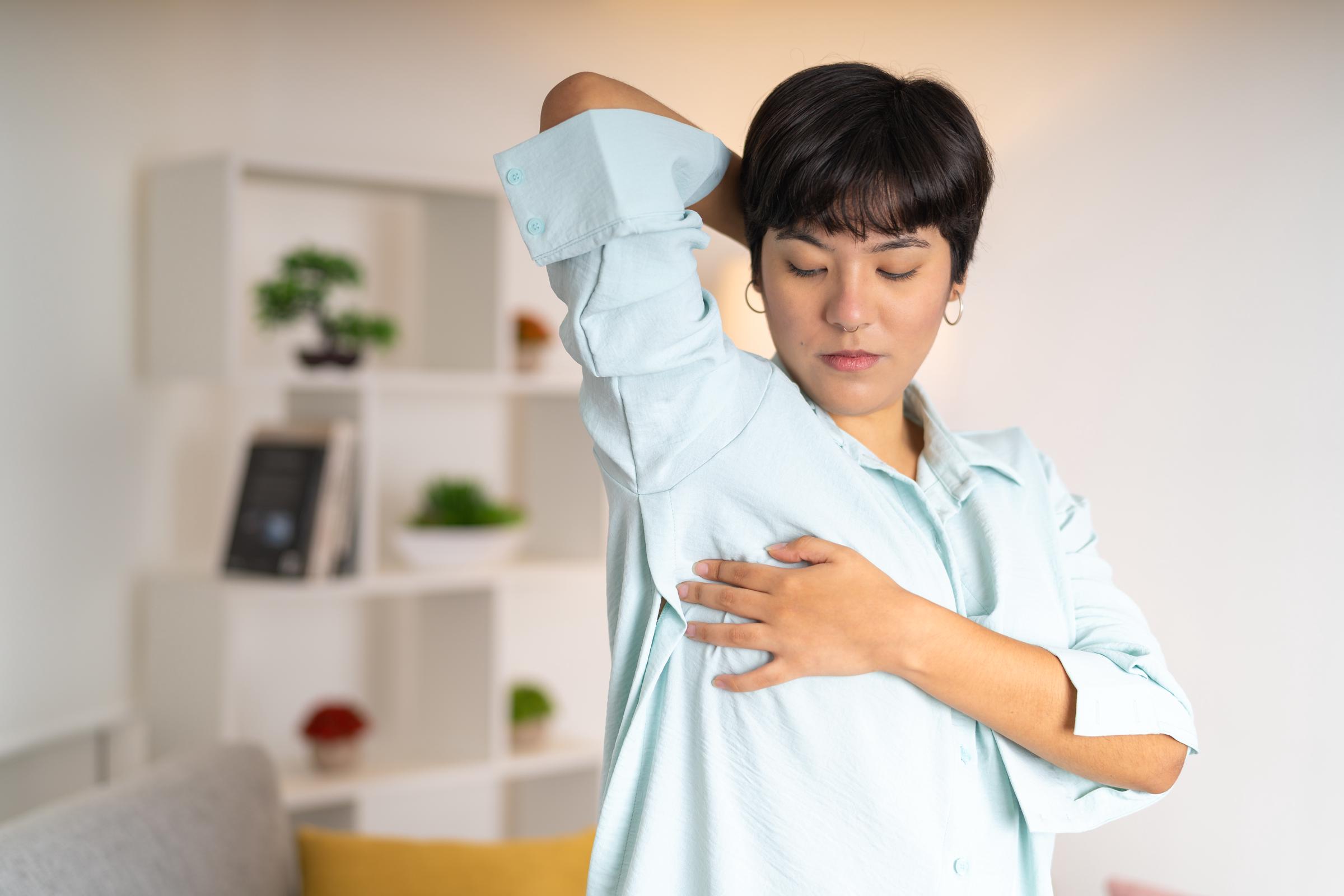 A worried woman doing self breast exam at home | Source: Getty Images