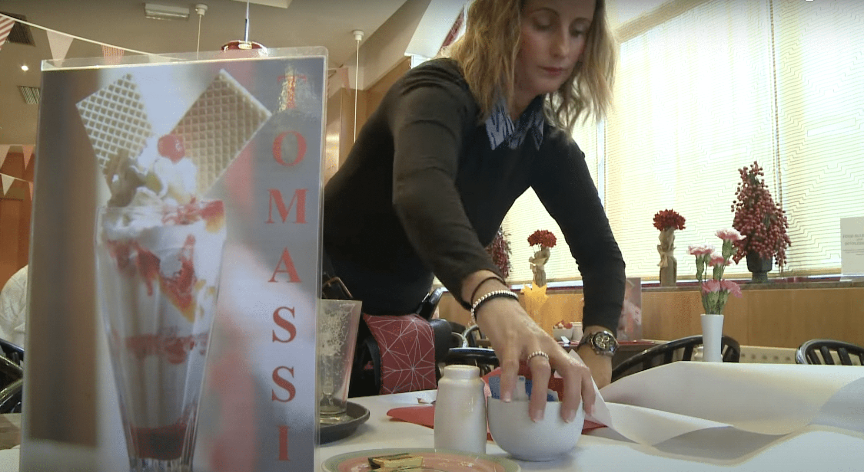 Congrave pictured setting up a table at Tomassi's.  |  Source: YouTube.com/On Demand News