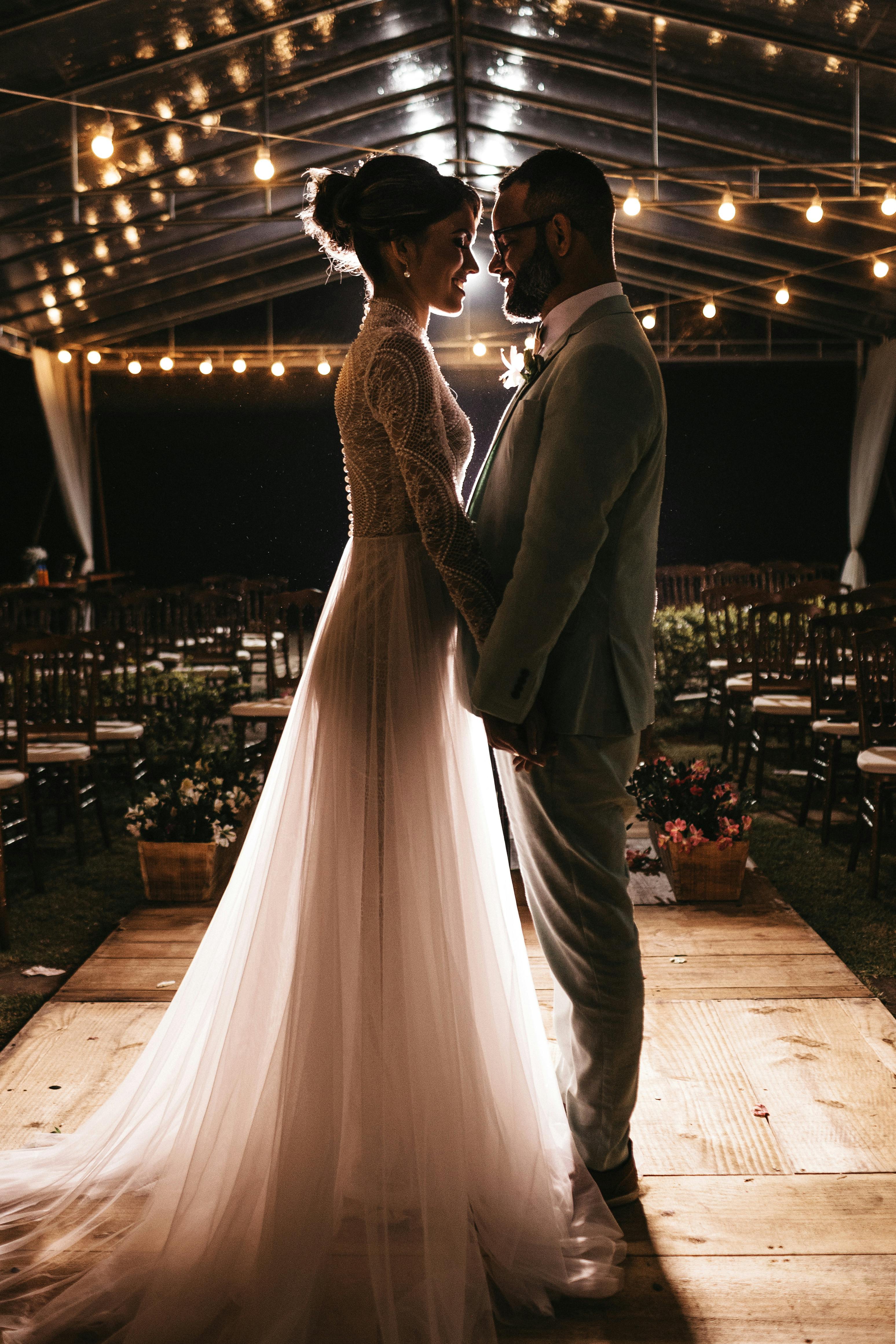 A happy bride and groom holding hands | Source: Pexels