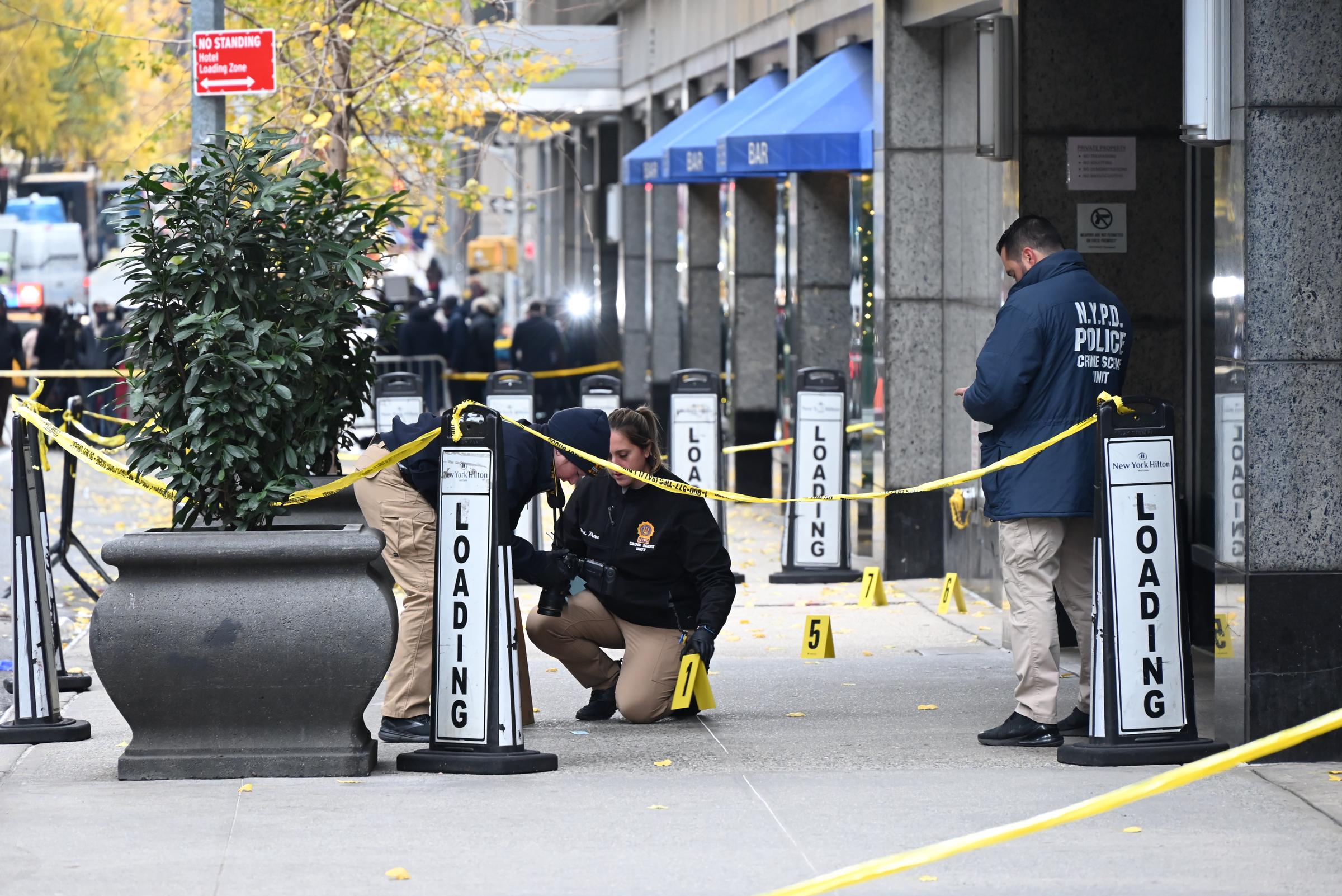 Police gather outside of a Hilton Hotel in Midtown Manhattan where United Healthcare CEO Brian Thompson was fatally shot in New York City, on December 4, 2024 | Source: Getty Images