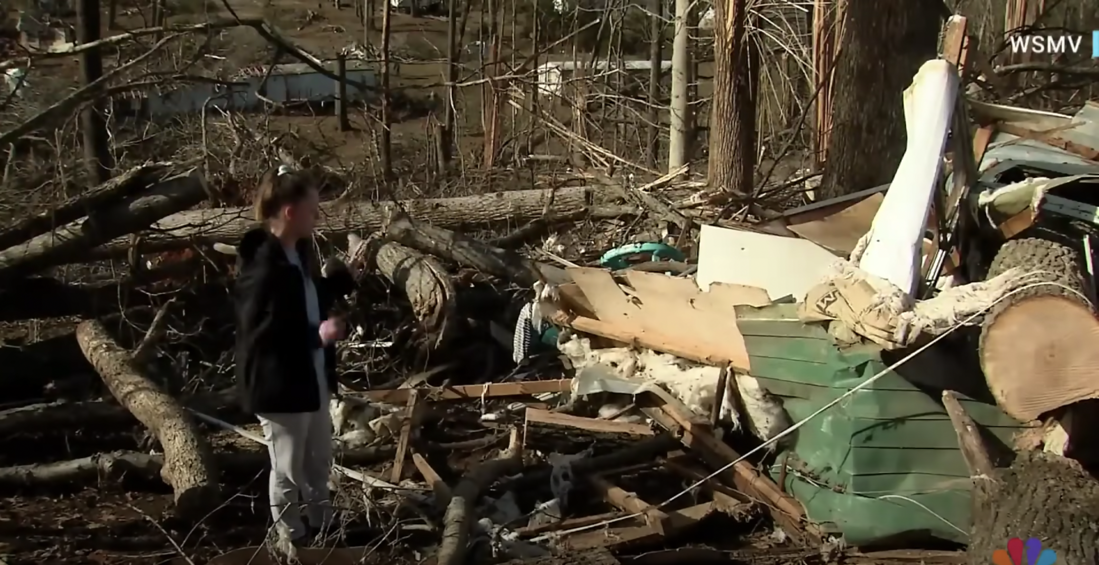 Sydney Moore standing near the rubble, as seen in a video dated December 16, 2023 | Source: youtube.com/NBC News