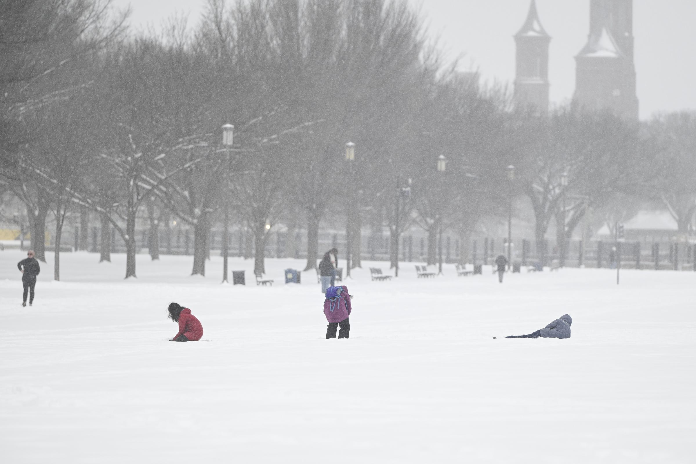 Civilians walking in the snow. | Source: Getty Images