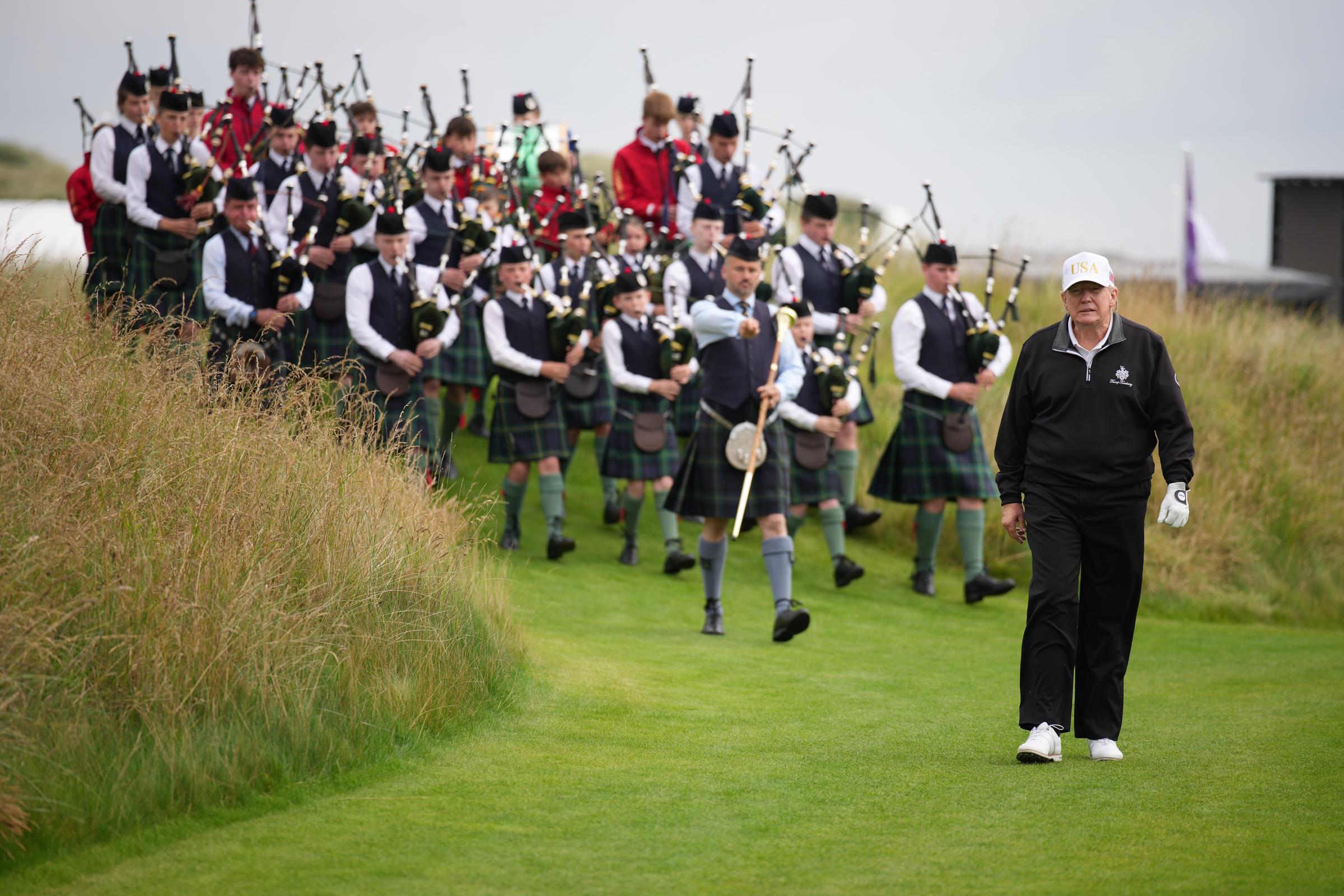 President Donald Trump walks on the course followed by a band at the ribbon-cutting ceremony at a new 18-hole course at Trump International Golf Links in Balmedie, Scotland on July 29, 2025 | Source: Getty Images