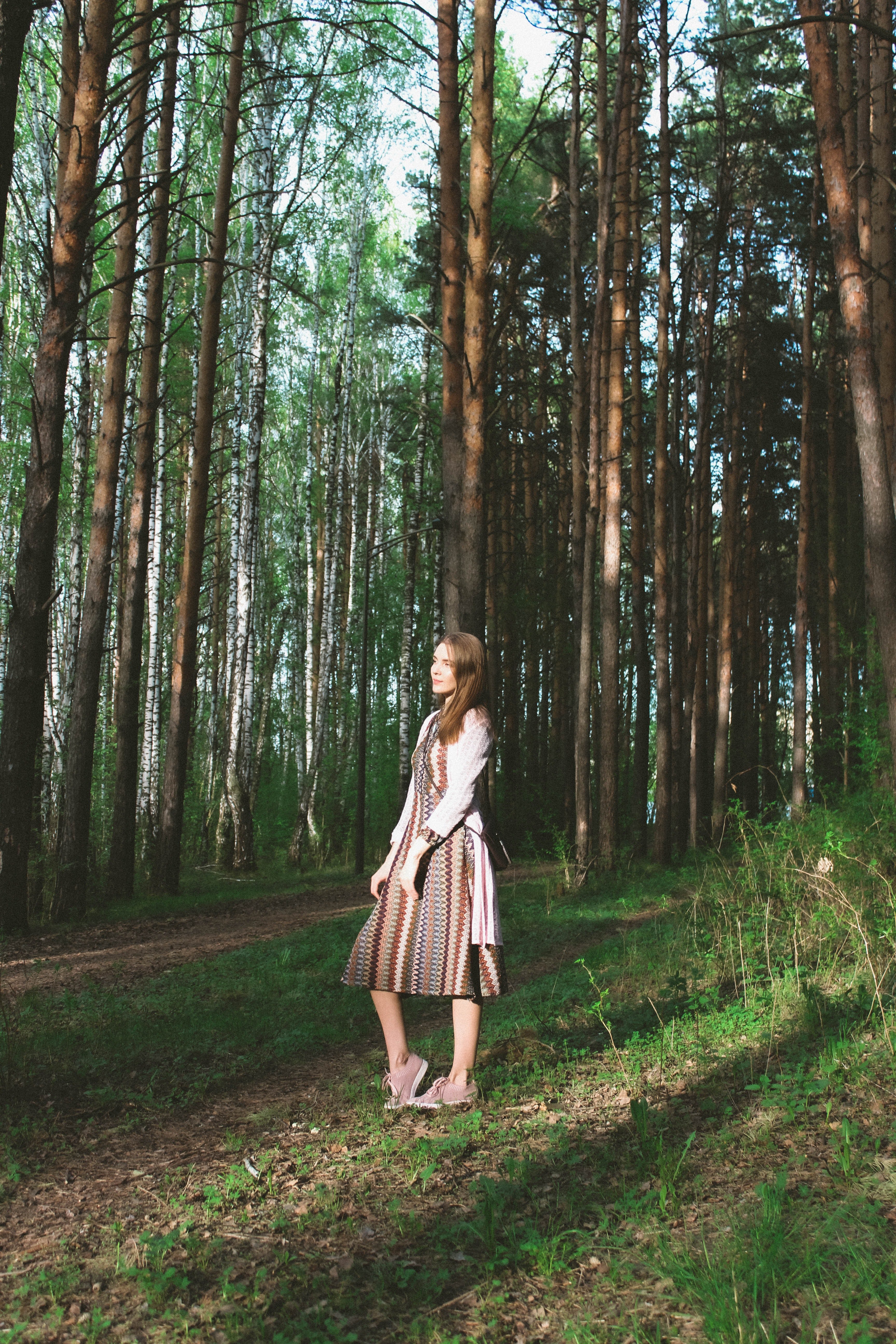 A woman in a dress standing in the forest. | Pexels/ Angelina Lobanova