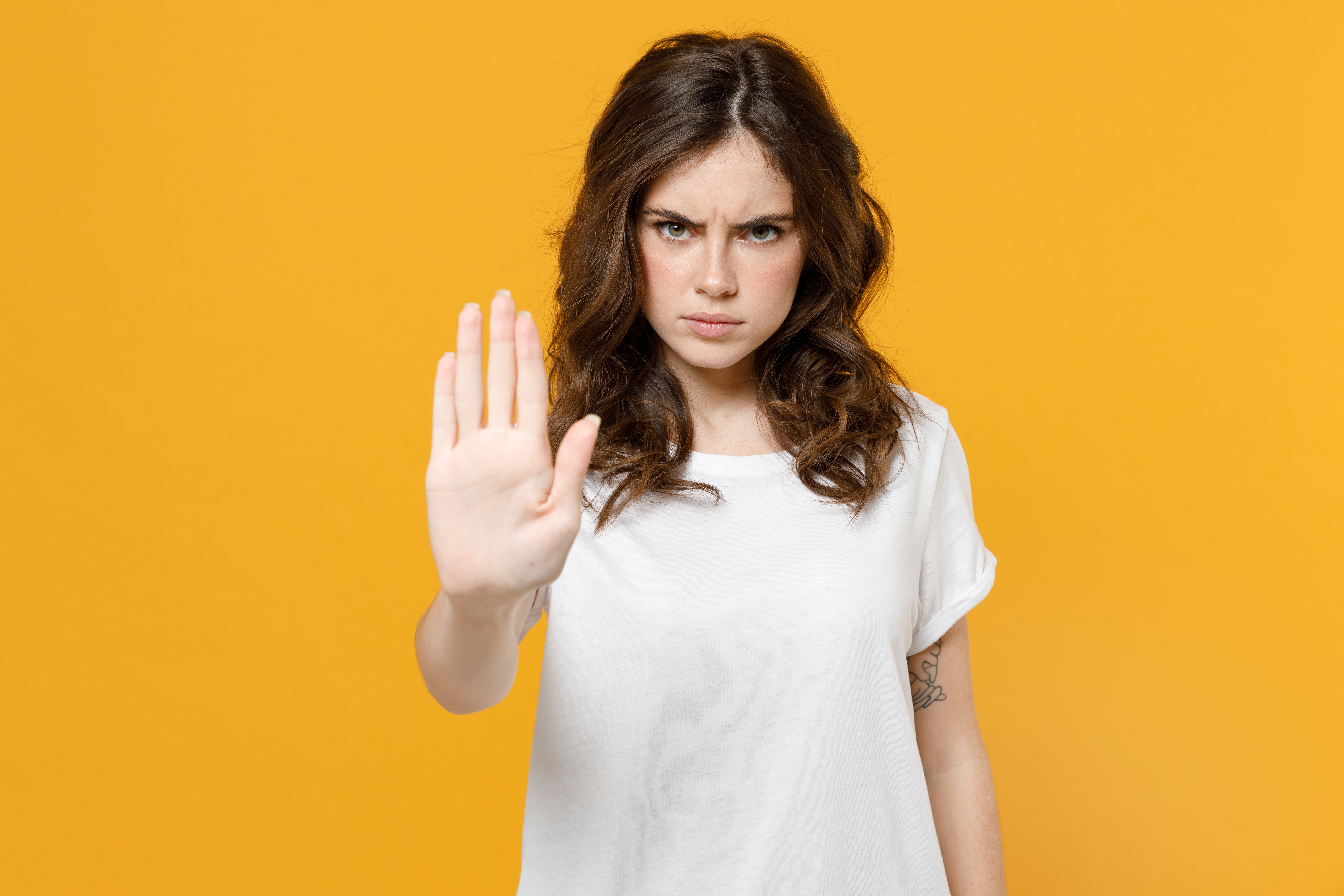 An angry young girl signaling to stop | Source: Shutterstock