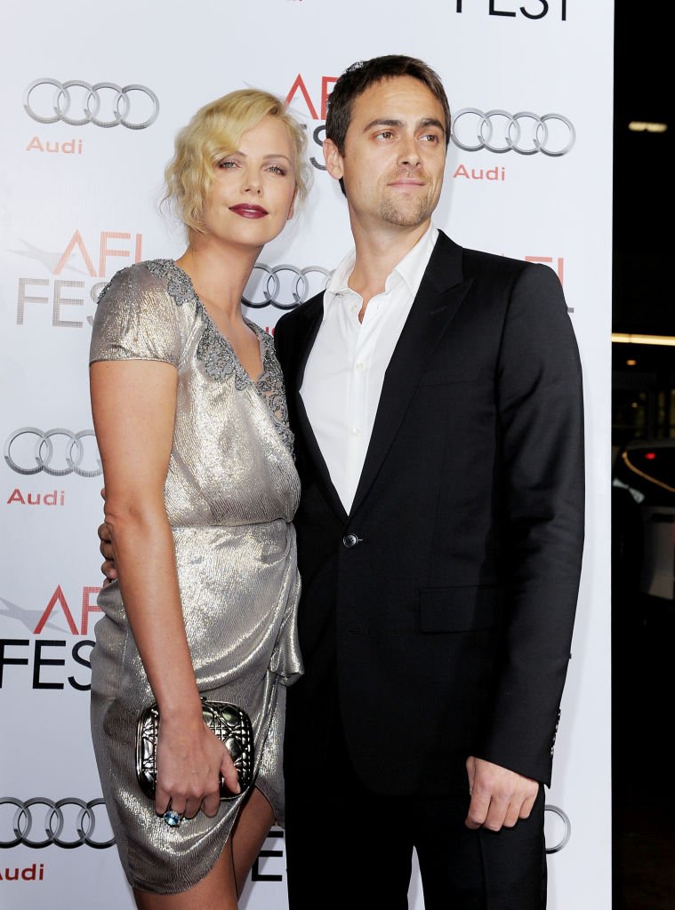 Charlize Theron and boyfriend actor Stuart Townsend arrive at the AFI FEST 2009 screening of "The Road"  | Getty Images