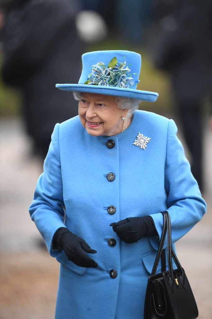 Queen Elizabeth II smiles at members of the public as she leaves following a church service at St Peter and St Paul church, in West Newton, Norfolk. | Photo: Getty Images