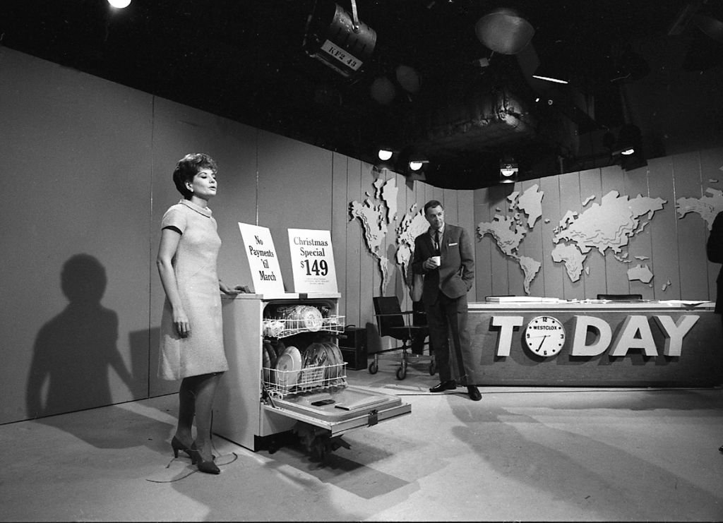 American broadcast journalists Barbara Walters and Hugh Downs (right) stand with a dishwasher on the 'Today' show set, New York, New York, 1966. | Source: Getty Images