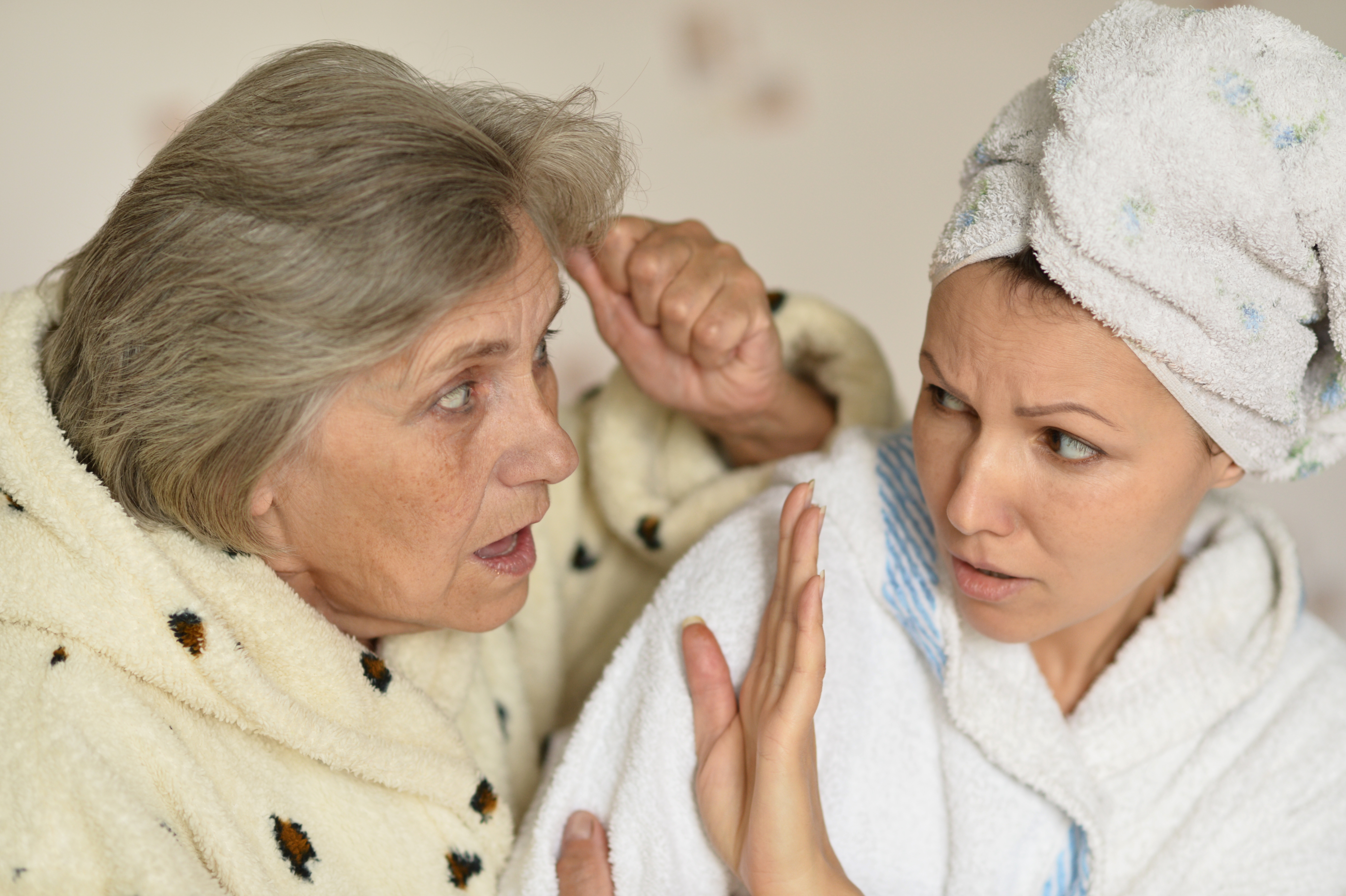 A pushy older lady and a younger woman | Source: Shutterstock