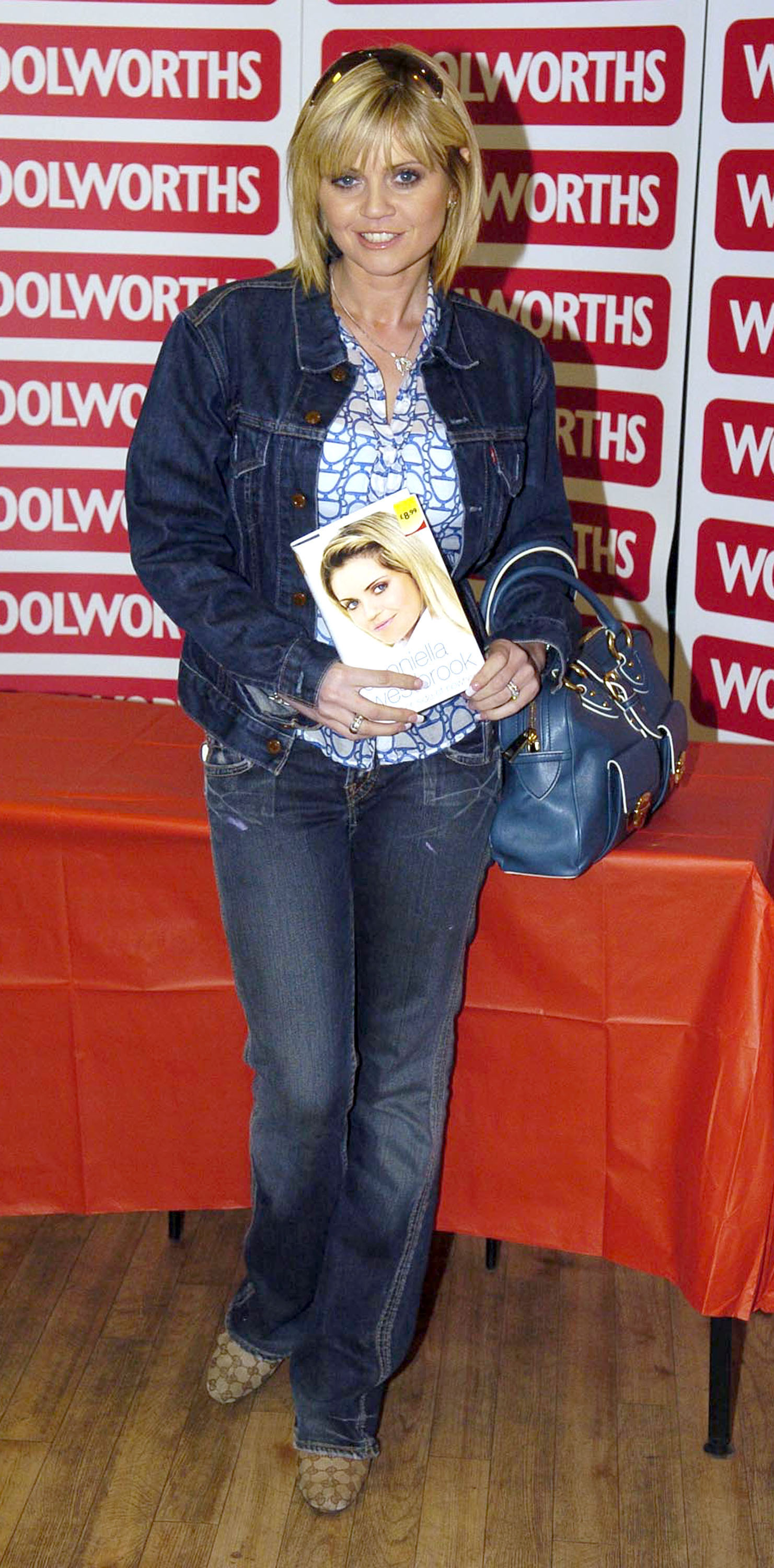 Casual, confident, and in control — Westbrook holds up her tell-all memoir "Other Side of Nowhere" during the 2006 Essex signing, dressed in denim and radiating down-to-earth charm as she mingles with fans.