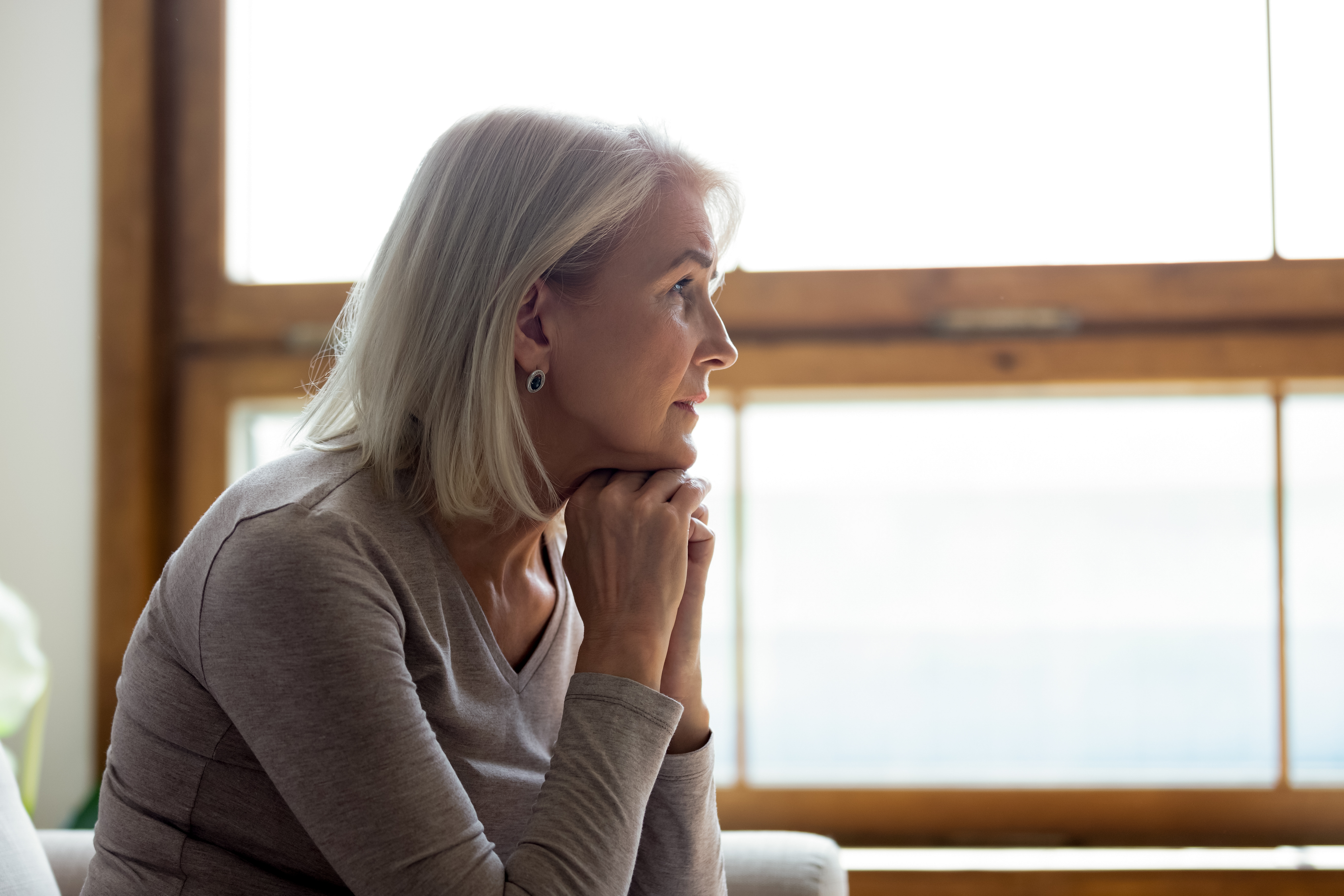 A depressed senior woman pondering over a past event | Source: Shutterstock