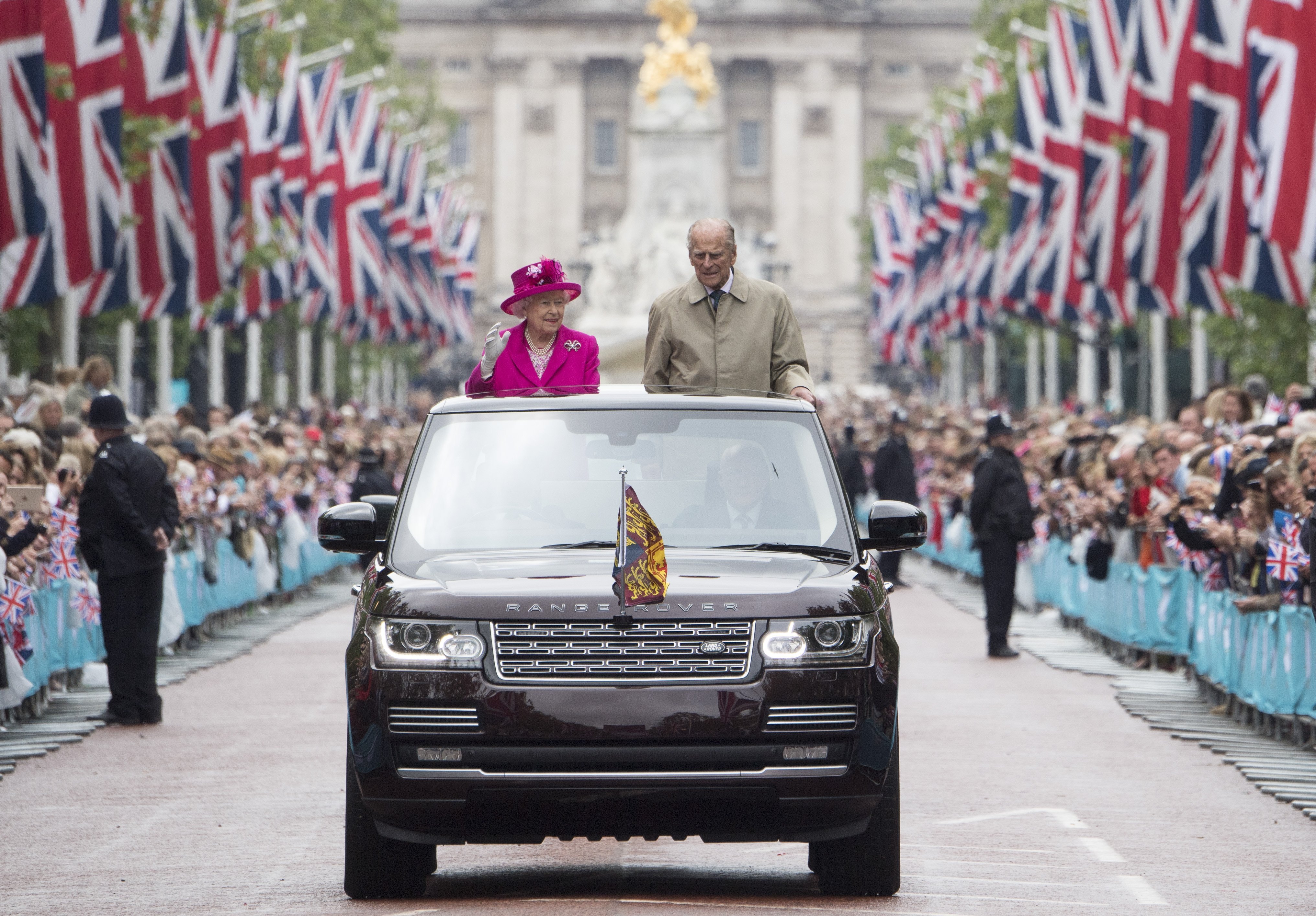 Queen Elizabeth and Prince Philip during a procession - Getty Images