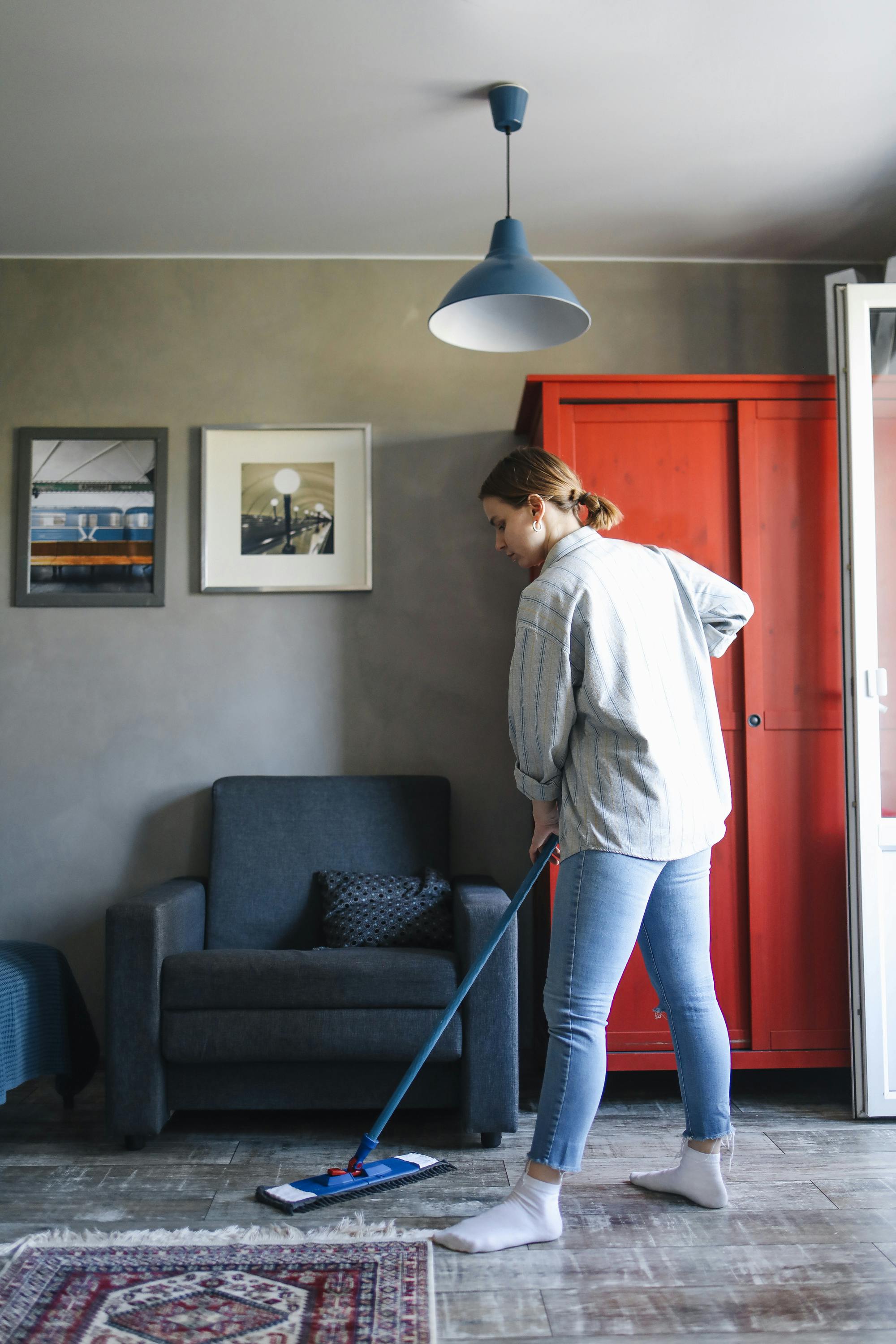 A woman cleaning her living room | Source: Pexels