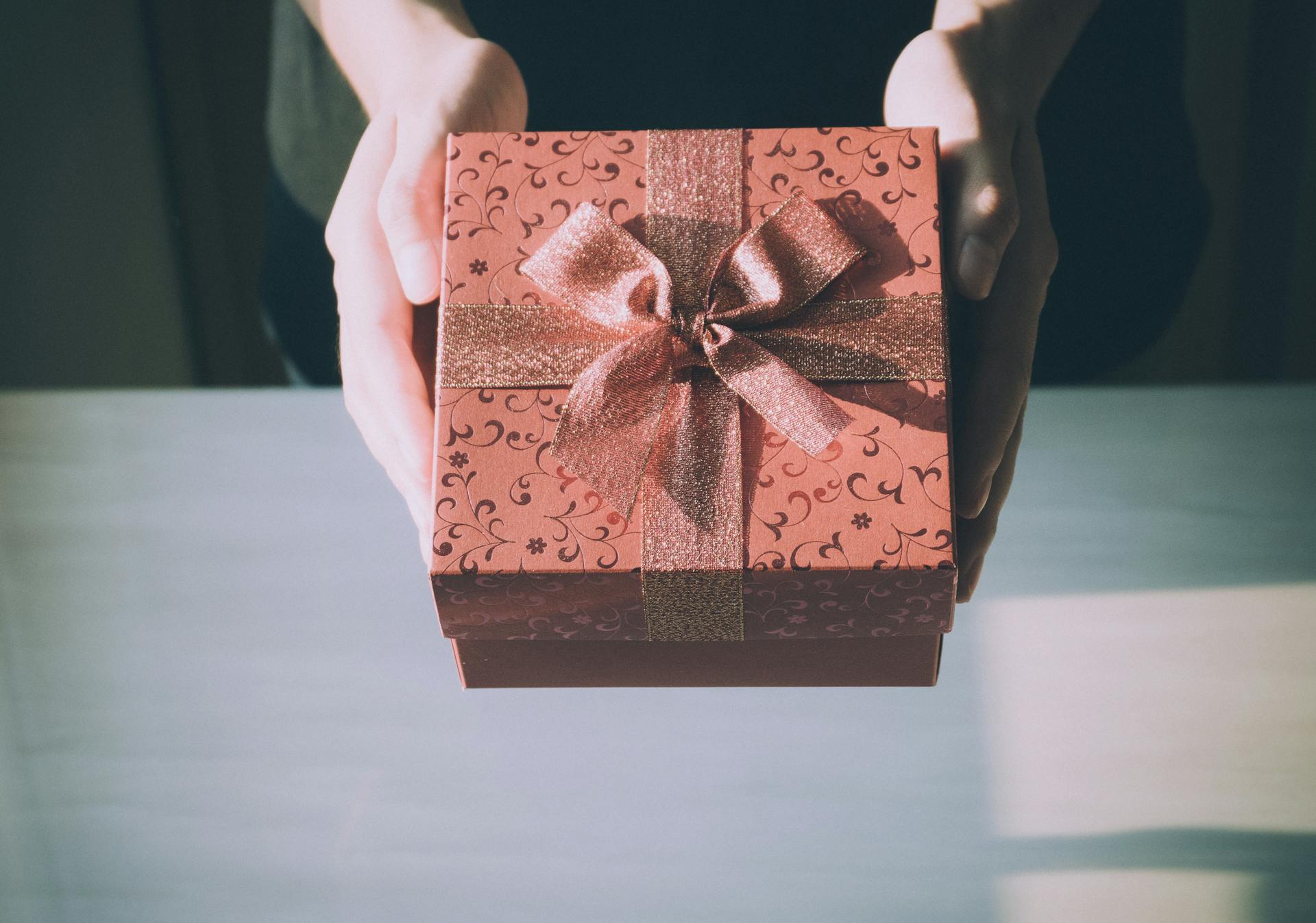 A person holding out a gift | Source: Pexels