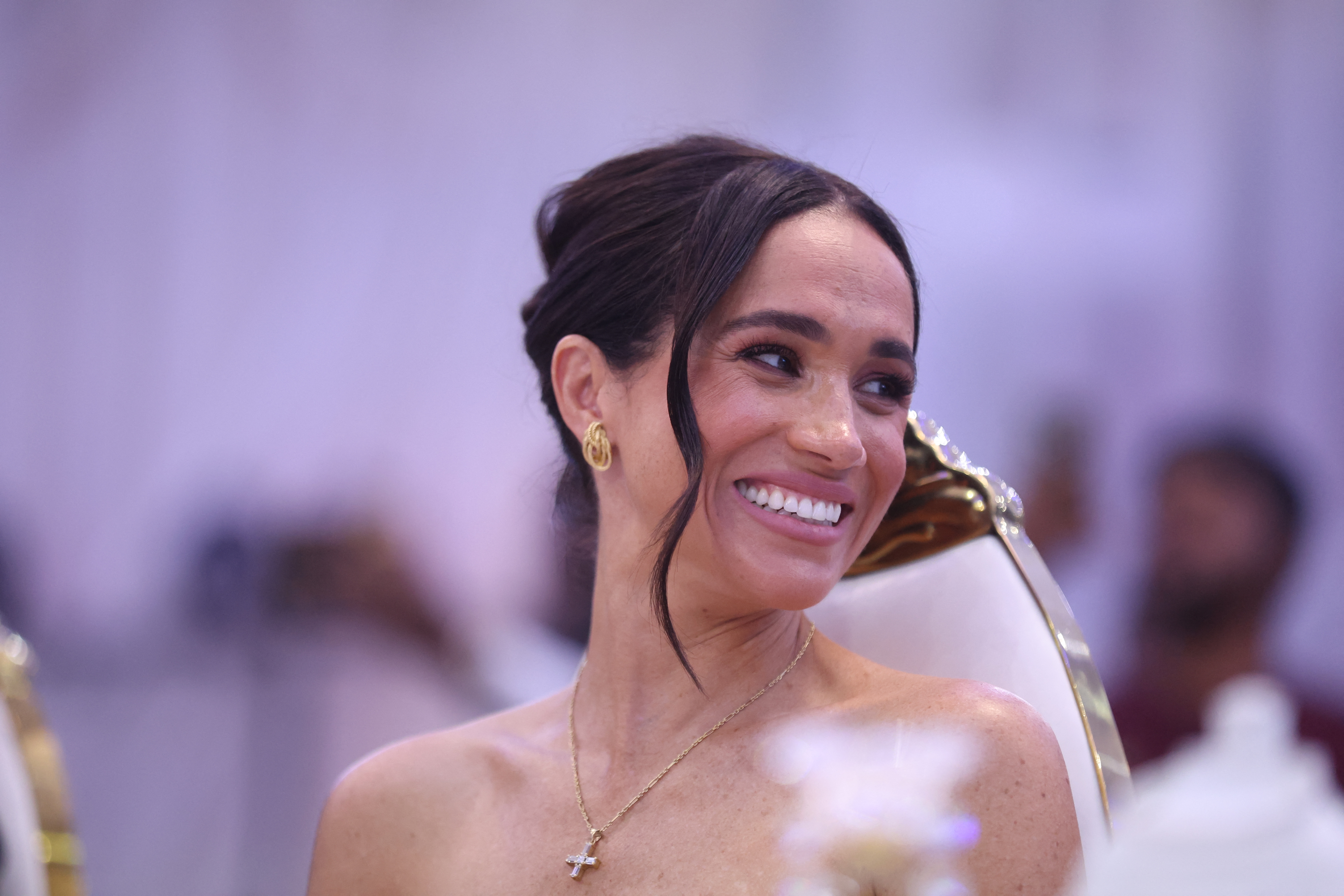 Meghan Markle smiles as she attends a Sit Out with Prince Harry at the Nigerian Defence Headquarters in Abuja on May 11, 2024, in Nigeria. | Source: Getty Images