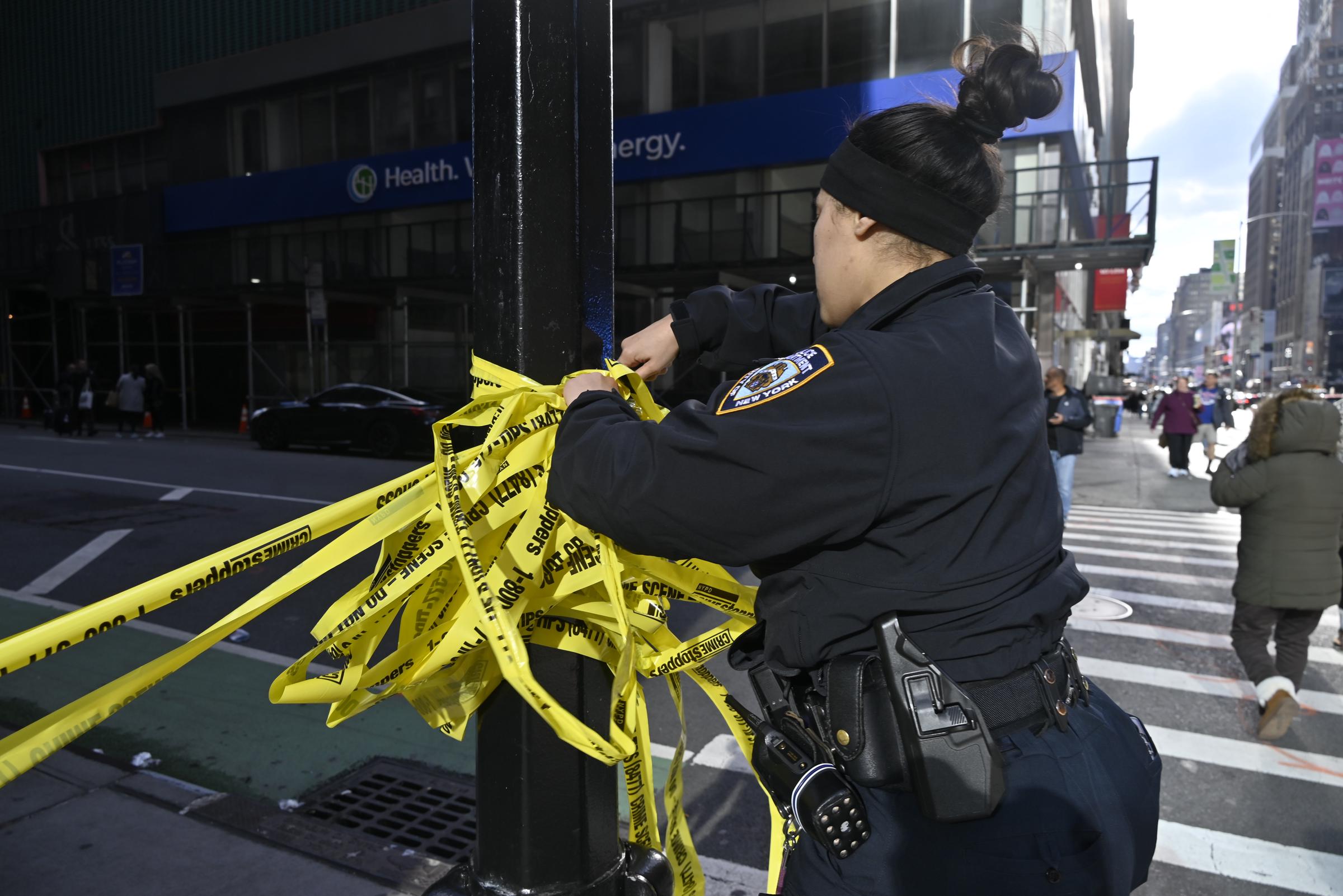 A police officer cordons the scene after Kris Boyd was shot in Midtown, Manhattan, New York on November 16, 2025. | Source: Getty Images