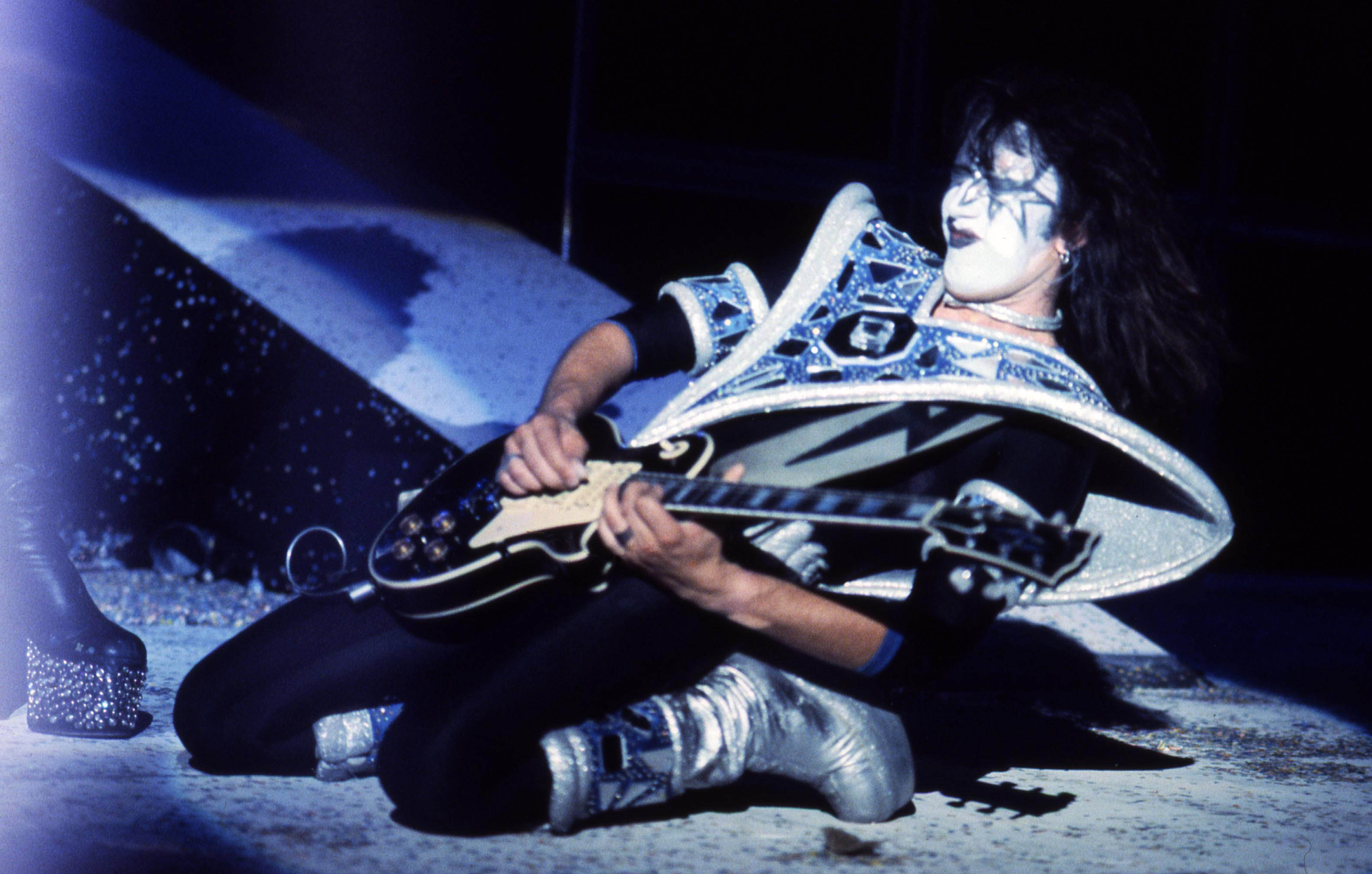Ace Frehley performing live on stage, playing Gibson Les Paul guitar on January 1, 1977 | Source: Getty Images