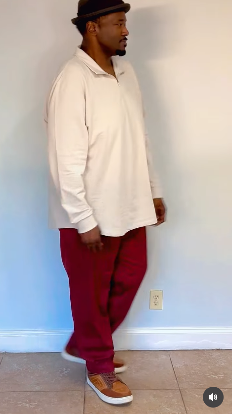 Quinton Aaron's tan sneakers and a tiled floor complete the simple indoor setting as he appears mid-step. | Source: Instagram/officialquintonaaron