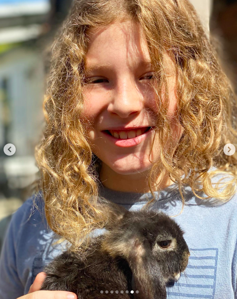 Finn Davey McDermott posing for a picture with a rabbit, posted on August 31, 2021 | Source: Instagram/torispelling
