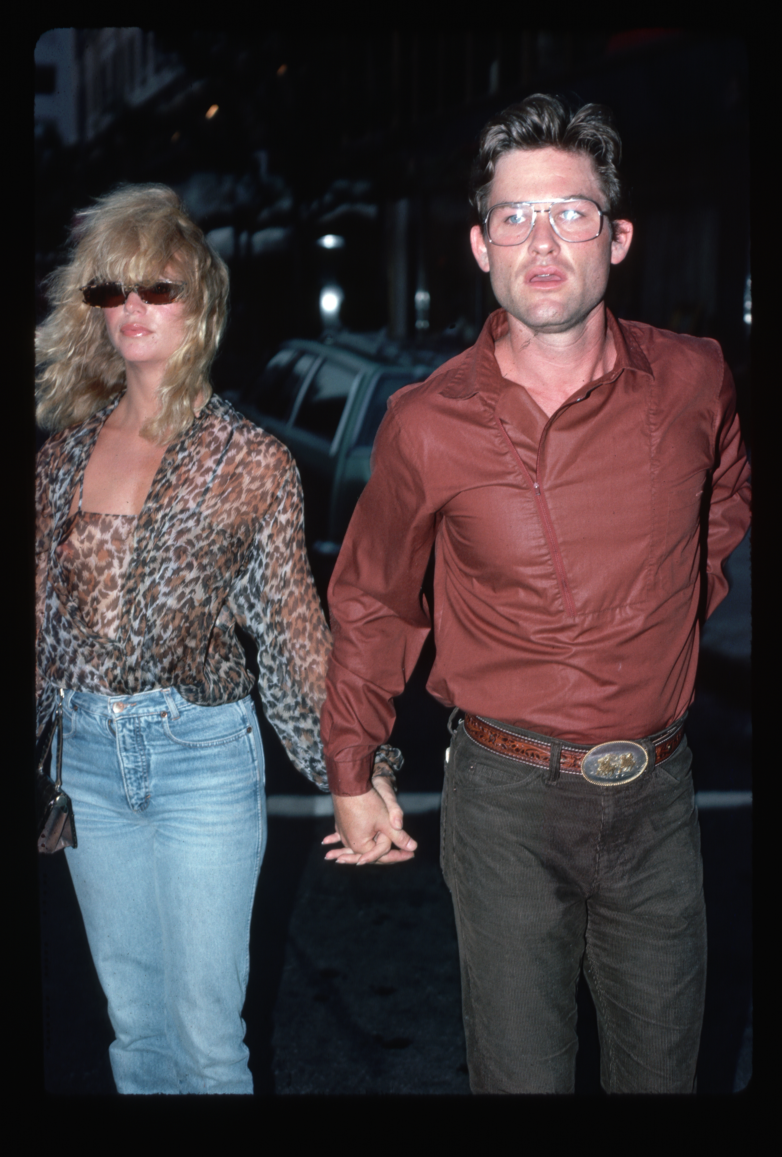 An undated photo of Goldie Hawn and Kurt Russell pictured holding hands outdoors at night | Source: Getty Images