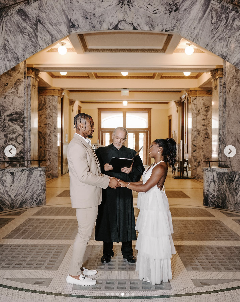 Jonathan Owens and Simone Biles stand holding hands while a judge officiates their wedding, as seen in a post dated April 22, 2023 | Source: Instagram/simonebiles