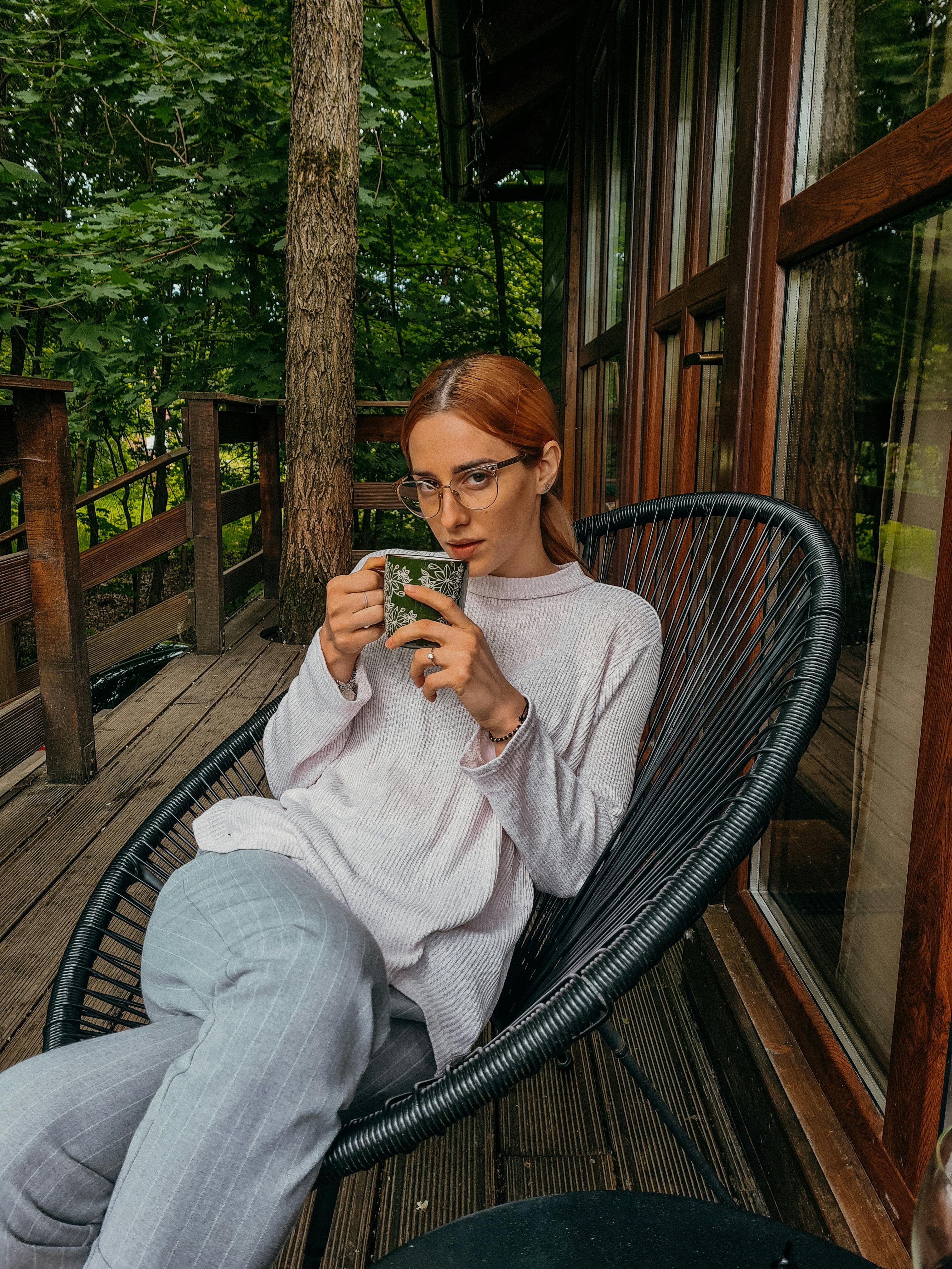 A woman sitting on her porch with tea | Source: Pexels