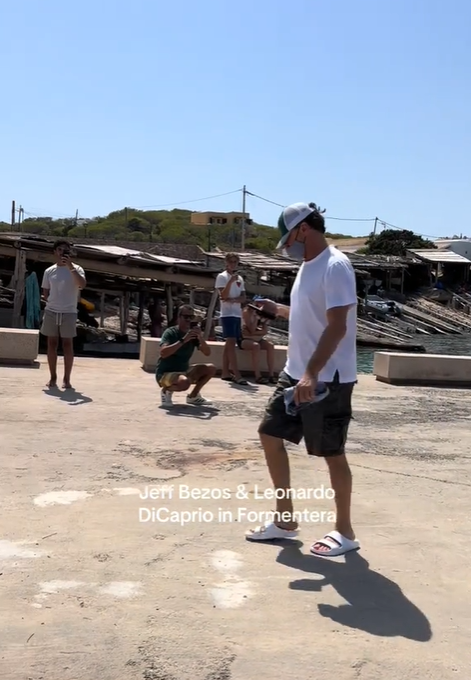 Leonardo DiCaprio is seen walking behind Jeff Bezos along a pier in Formentera, from a video post dated August 7, 2025 | Source: TikTok/albayalgomas