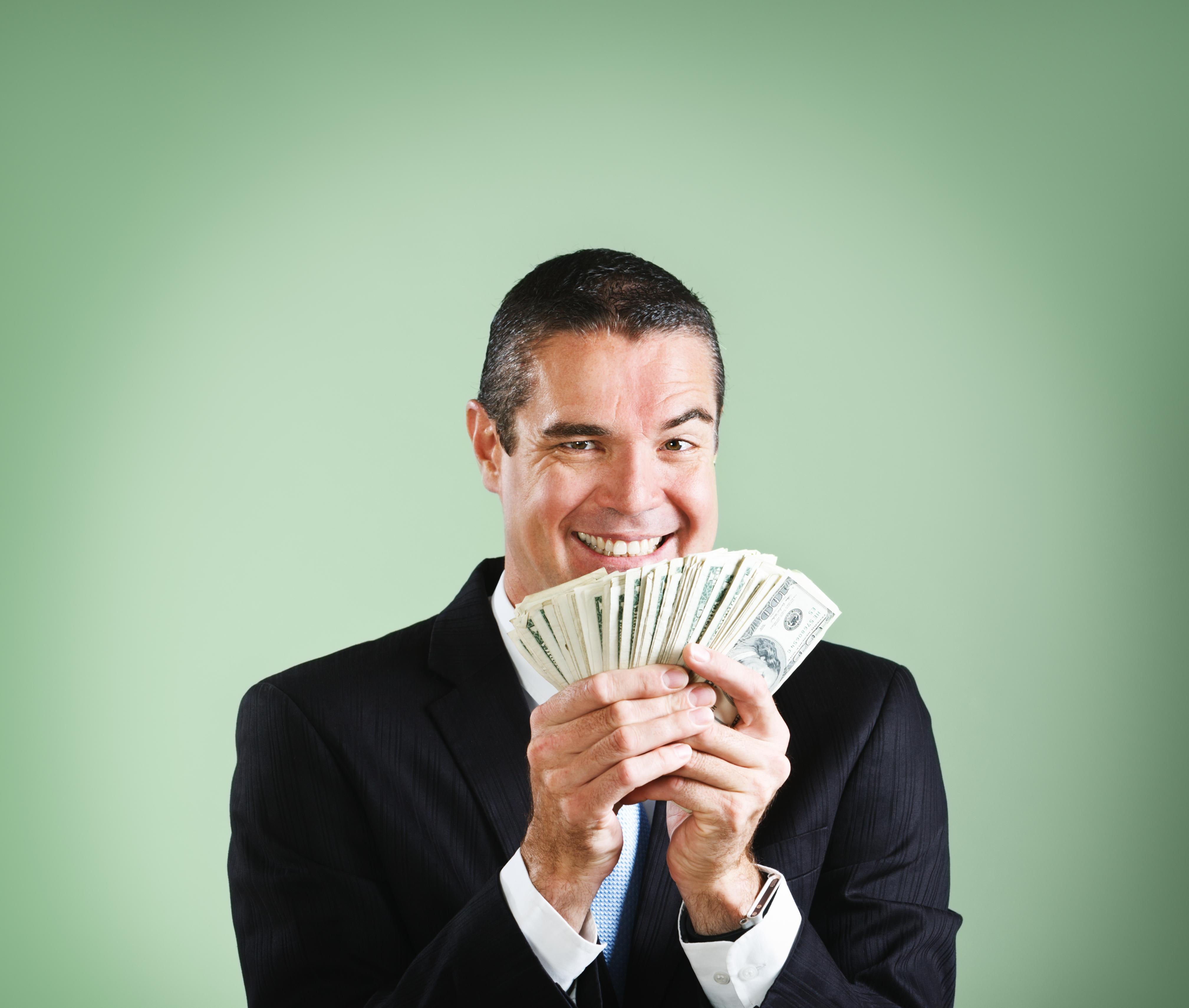 A happy man holding money | Source: Getty Images