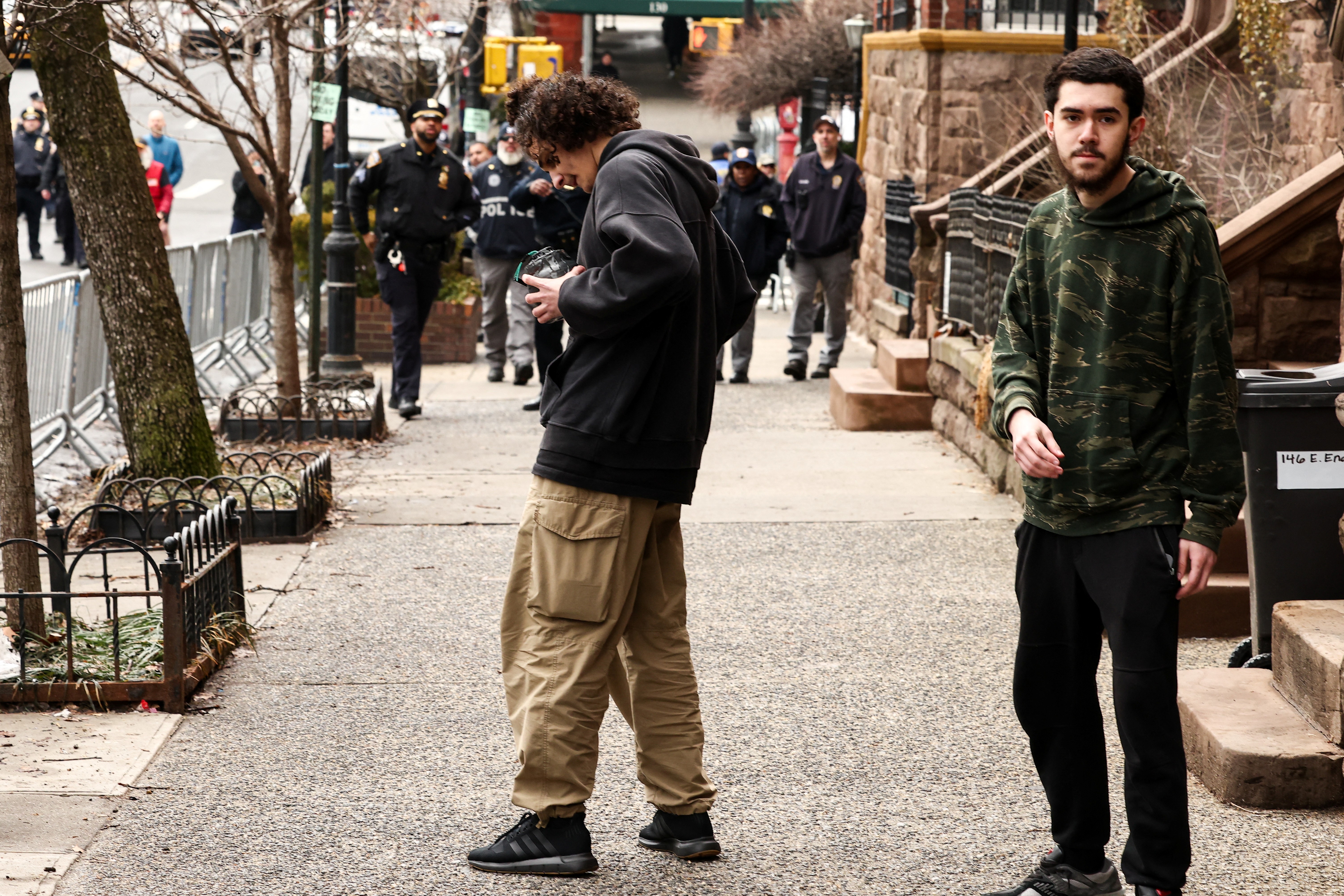 Two suspects seen amid the protest as police officers approach. | Source: Getty Images