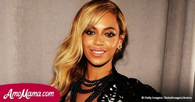 Beyonce flashes her gorgeous cleavage in a very low-cut jumpsuit as she sits on Jay-Z's lap