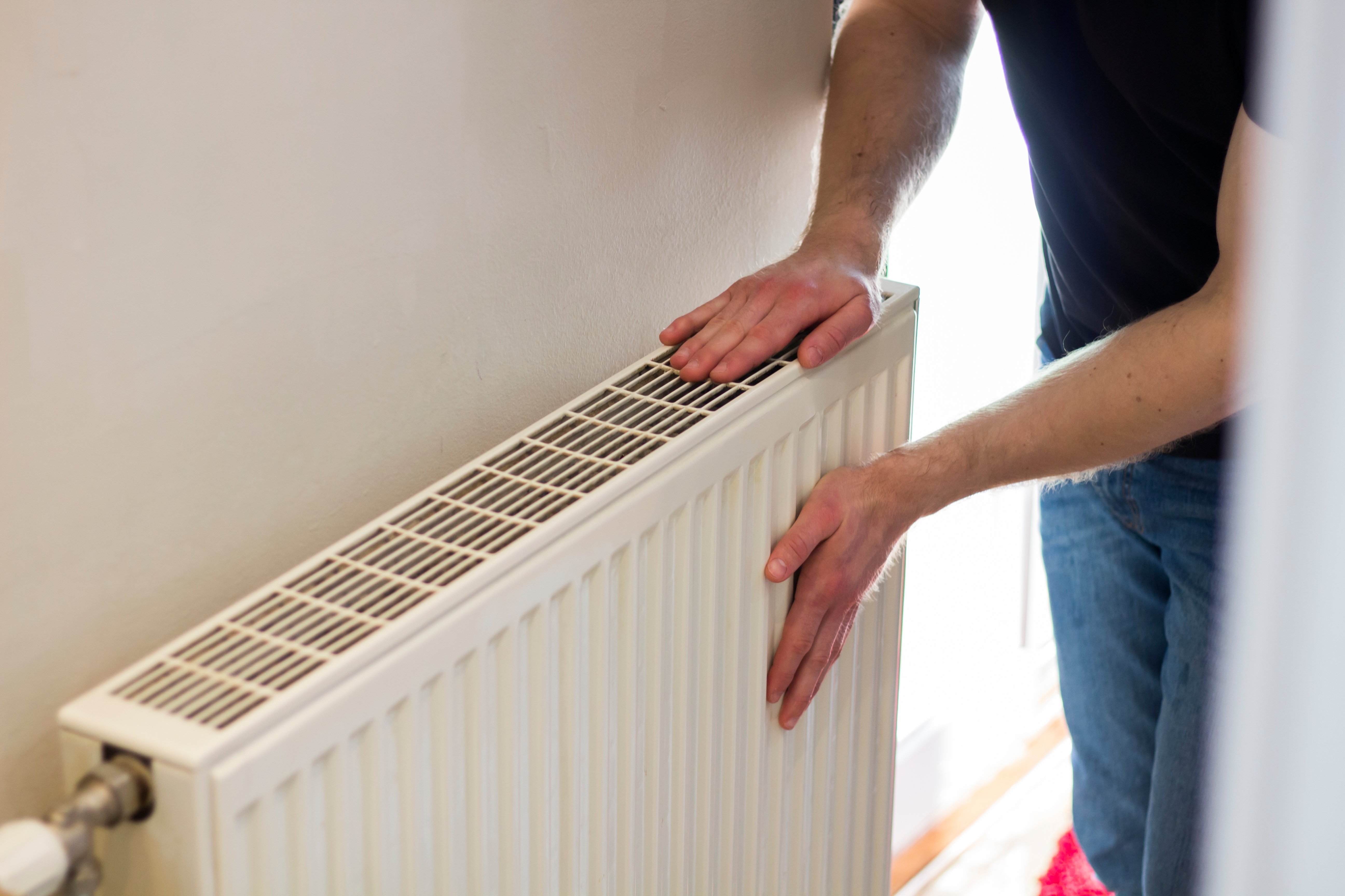 Man checking a radiator | Source: Shutterstock