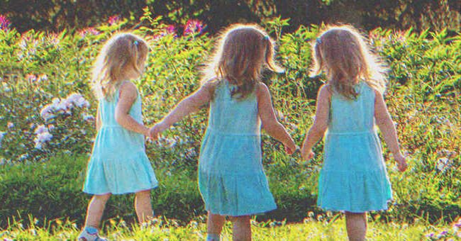 Triplets playing in a garden | Source: Shutterstock
