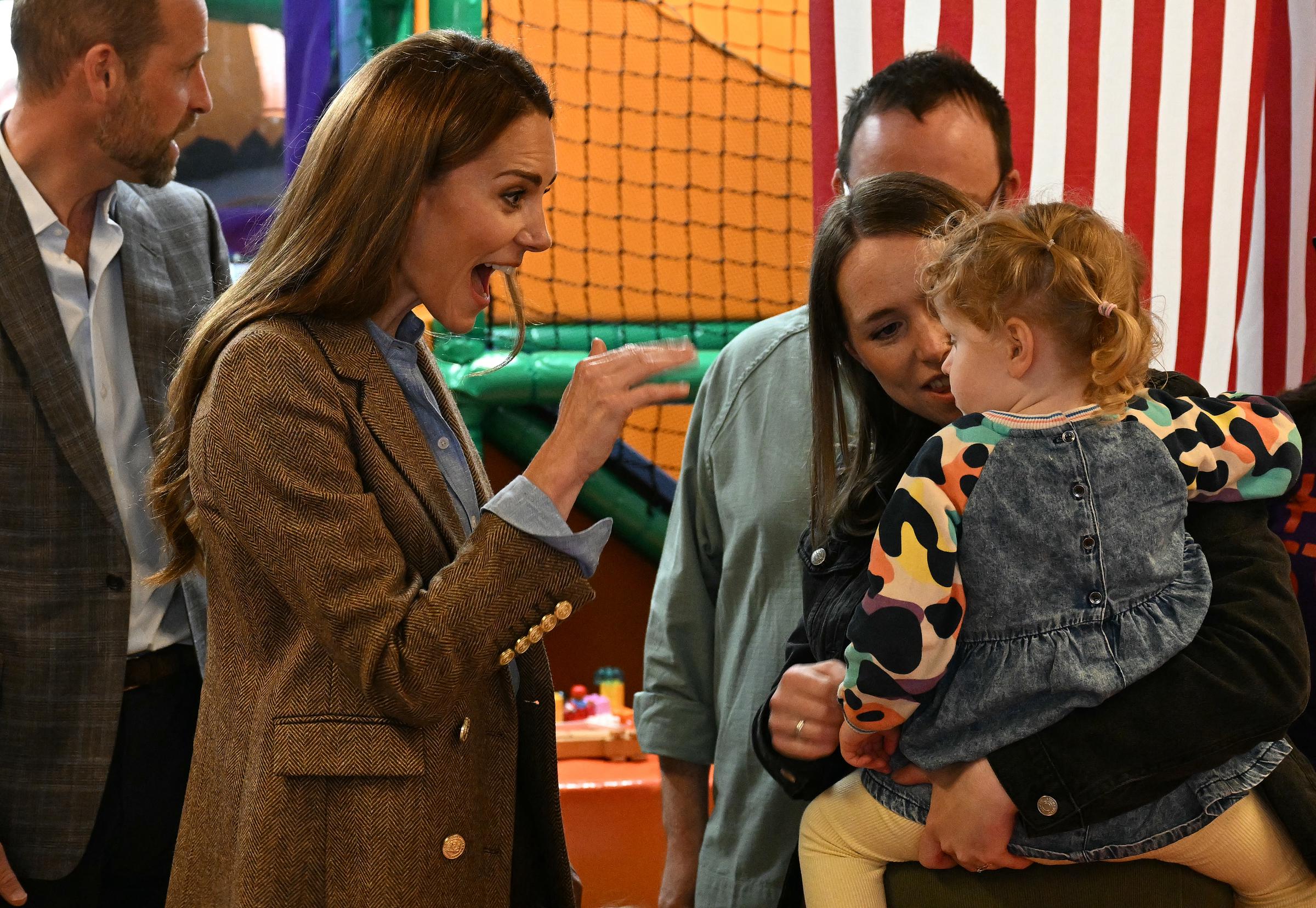 Catherine reacts playfully to a young child while visiting the soft play area inside Aros Hall in Tobermory. Her animated expression added a warm, personal touch to the couple's engagement with families on the Isle of Mull.
