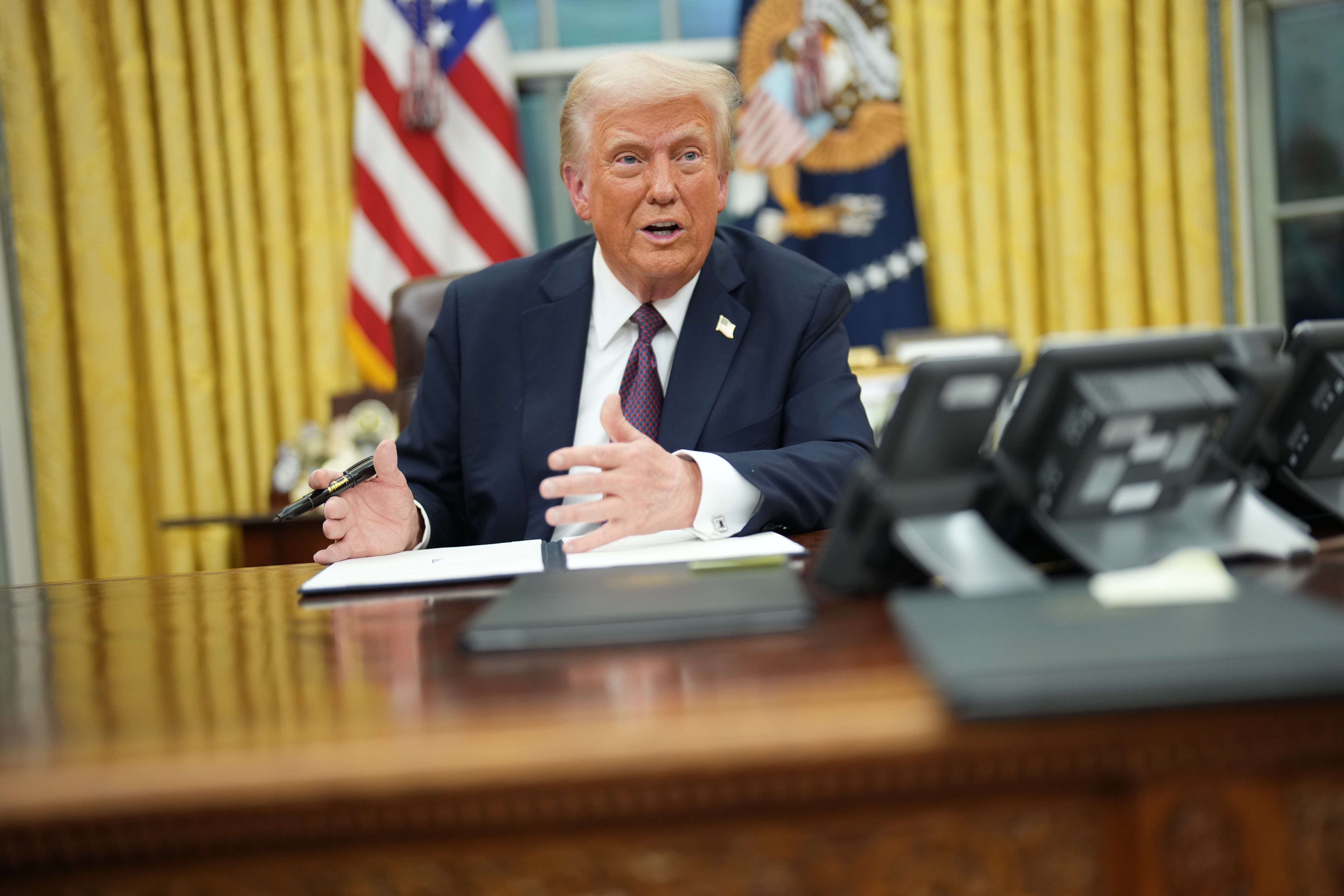 President Donald Trump signs a series of executive orders at the White House on January 20, 2025, in Washington, DC. | Source: Getty Images